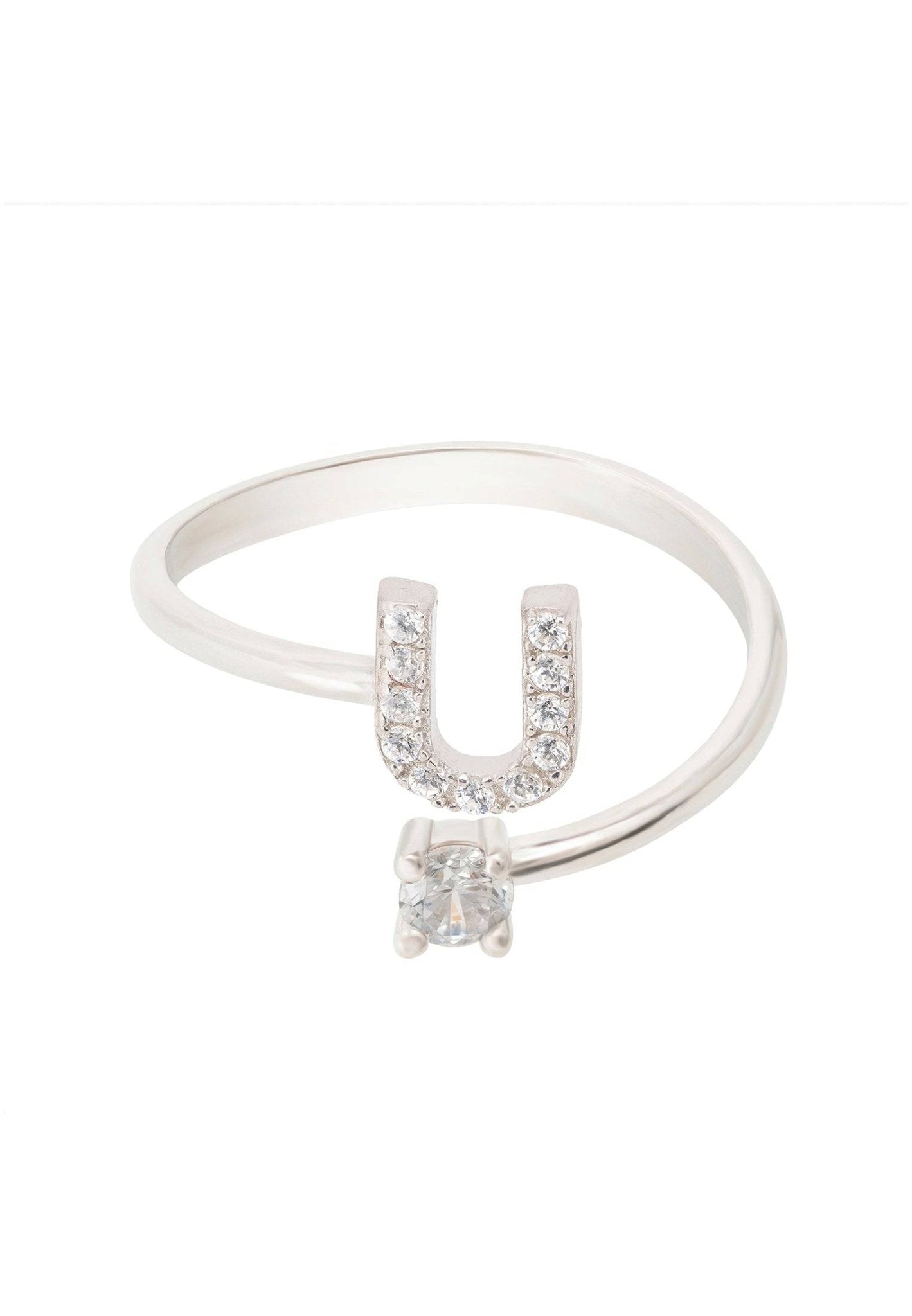 A delicate silver initial ring featuring a customizable letter and sparkling cubic zirconia, elegantly displayed in a jewelry box.