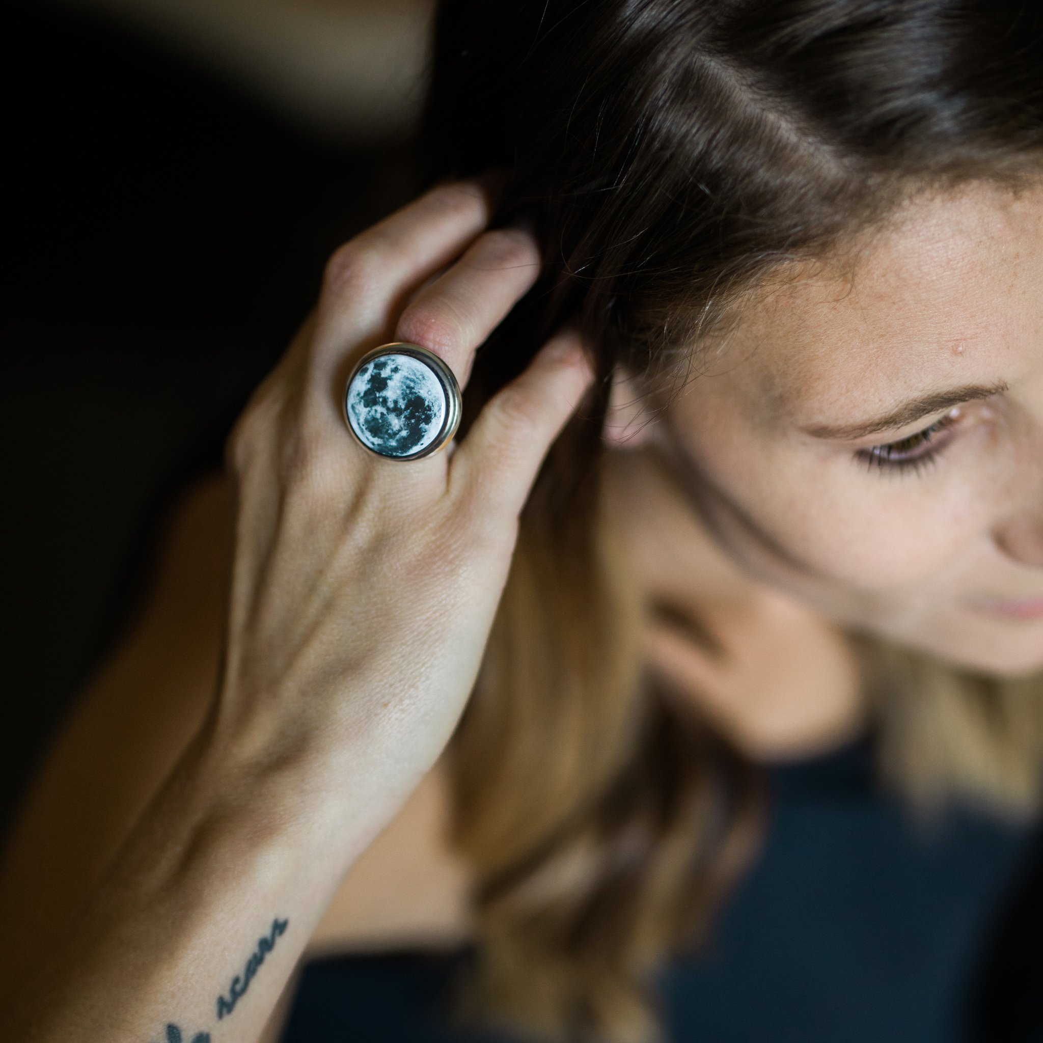 Interchangeable Moon Phase Ring showcasing five unique moon phase designs in silver and bronze tones, adjustable size with a wide band.