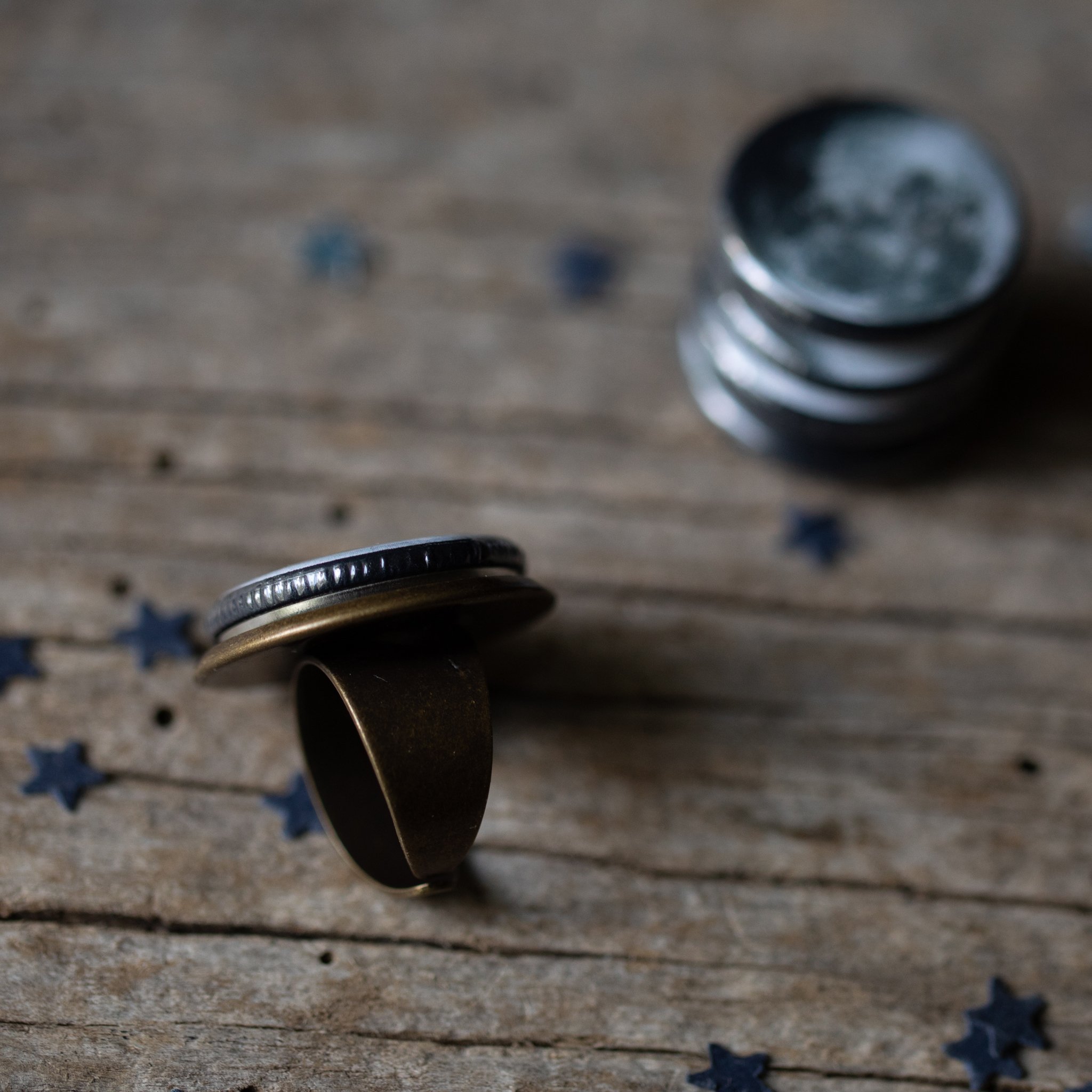 Interchangeable Moon Phase Ring showcasing five unique moon phase designs in silver and bronze tones, adjustable size with a wide band.