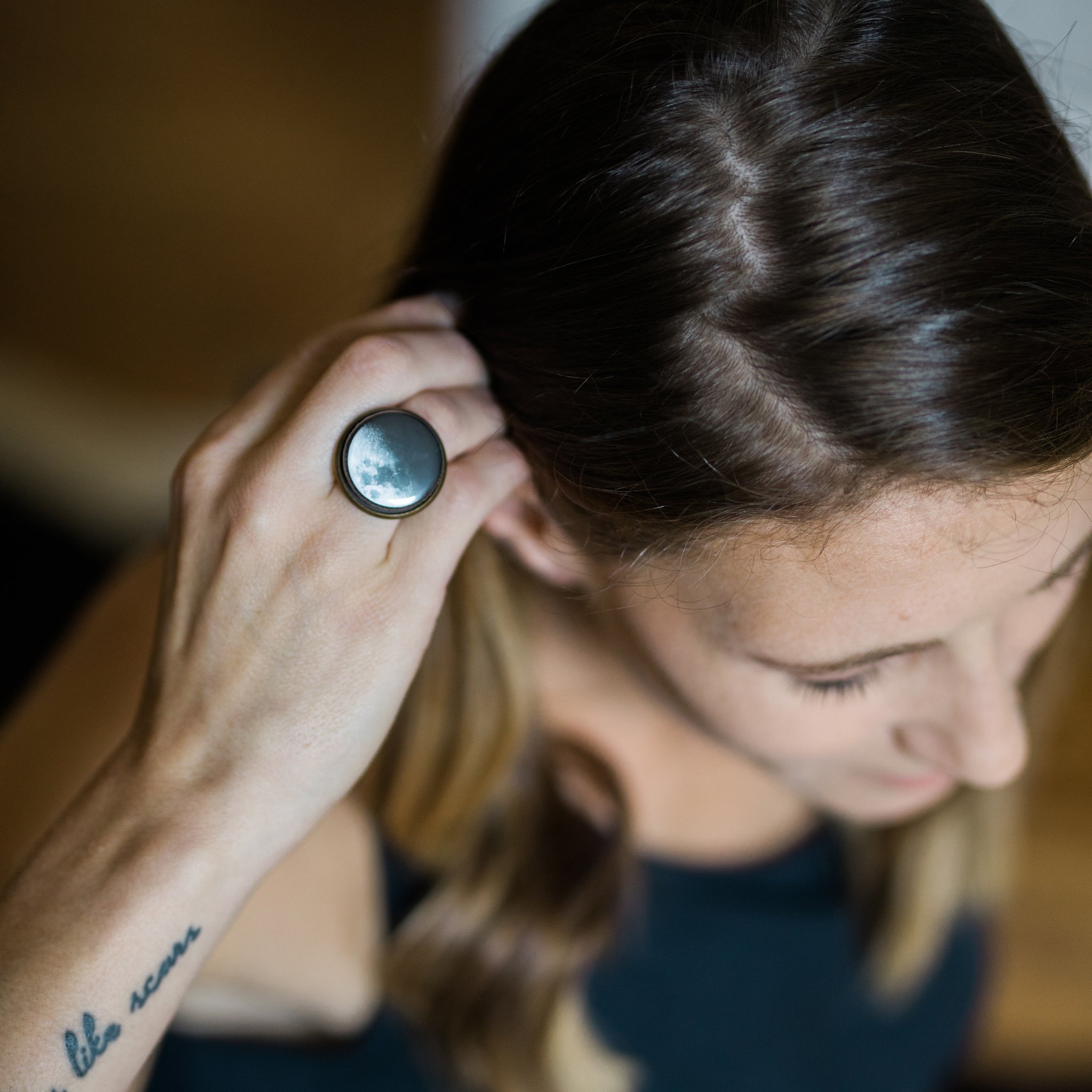 Interchangeable Moon Phase Ring showcasing five unique moon phase designs in silver and bronze tones, adjustable size with a wide band.