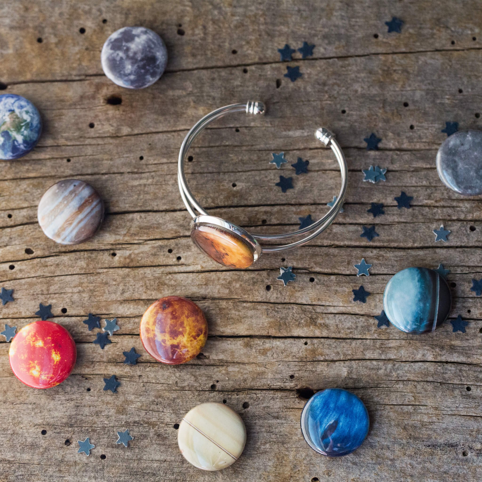 Interchangeable Solar System Cuff Bracelet featuring 8 planets, Moon, and Sun in antique bronze or silver-tone finish.