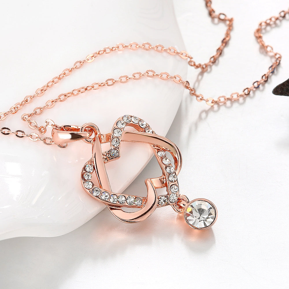 Intertwined Heart Necklace in 18K Rose Gold Plated with Crystals, elegantly designed and presented in a white gift box.