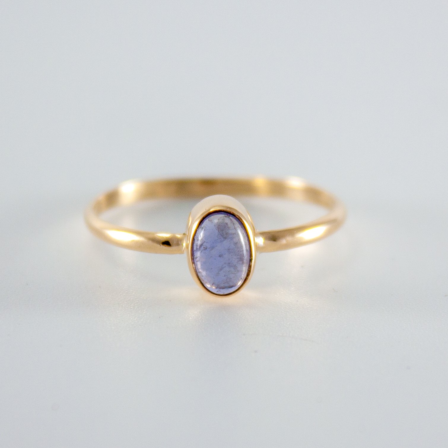 Iolite Oval Step Bezel Ring in 14k gold filled, showcasing a violet gemstone in a minimalist design.