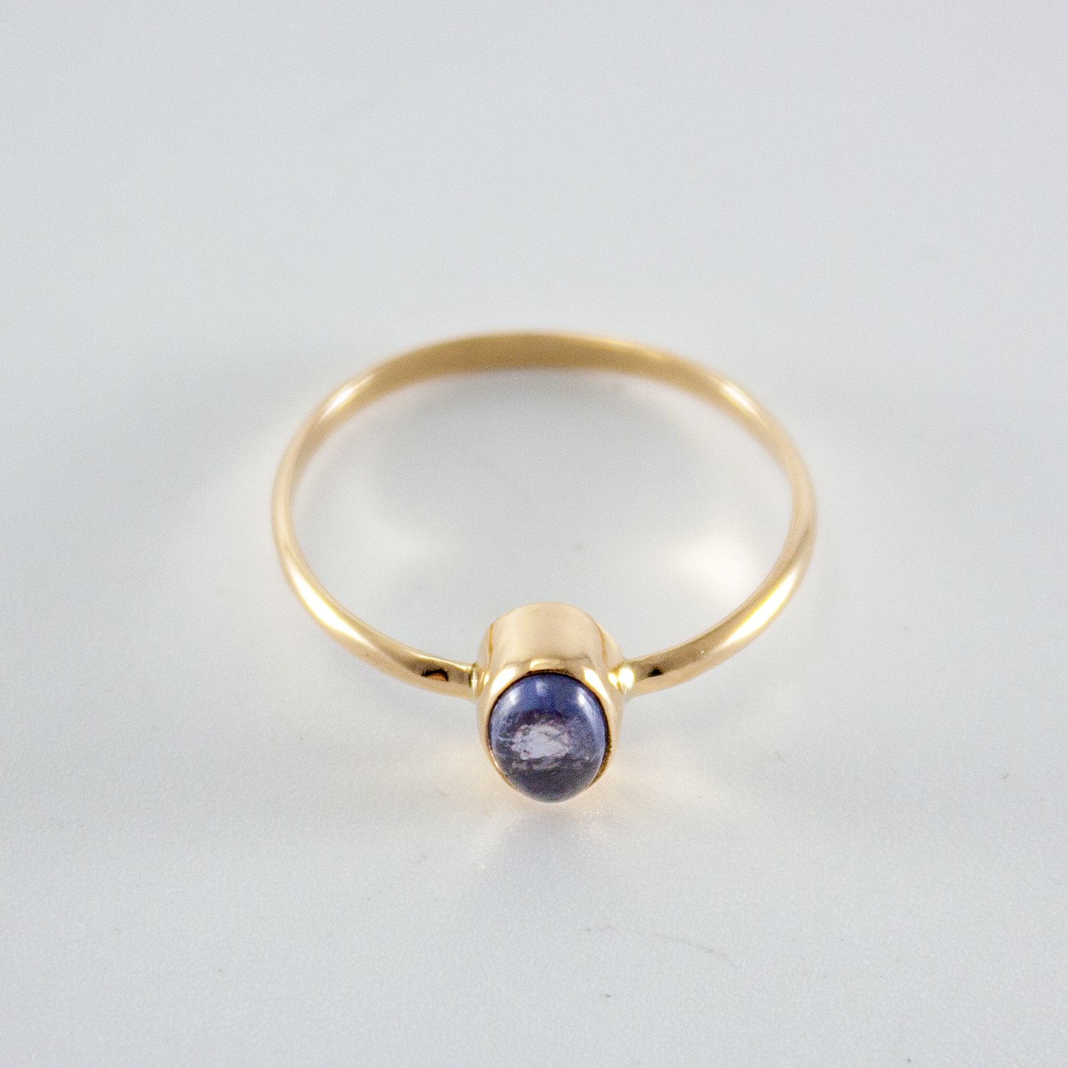 Iolite Oval Step Bezel Ring in 14k gold filled, showcasing a violet gemstone in a minimalist design.