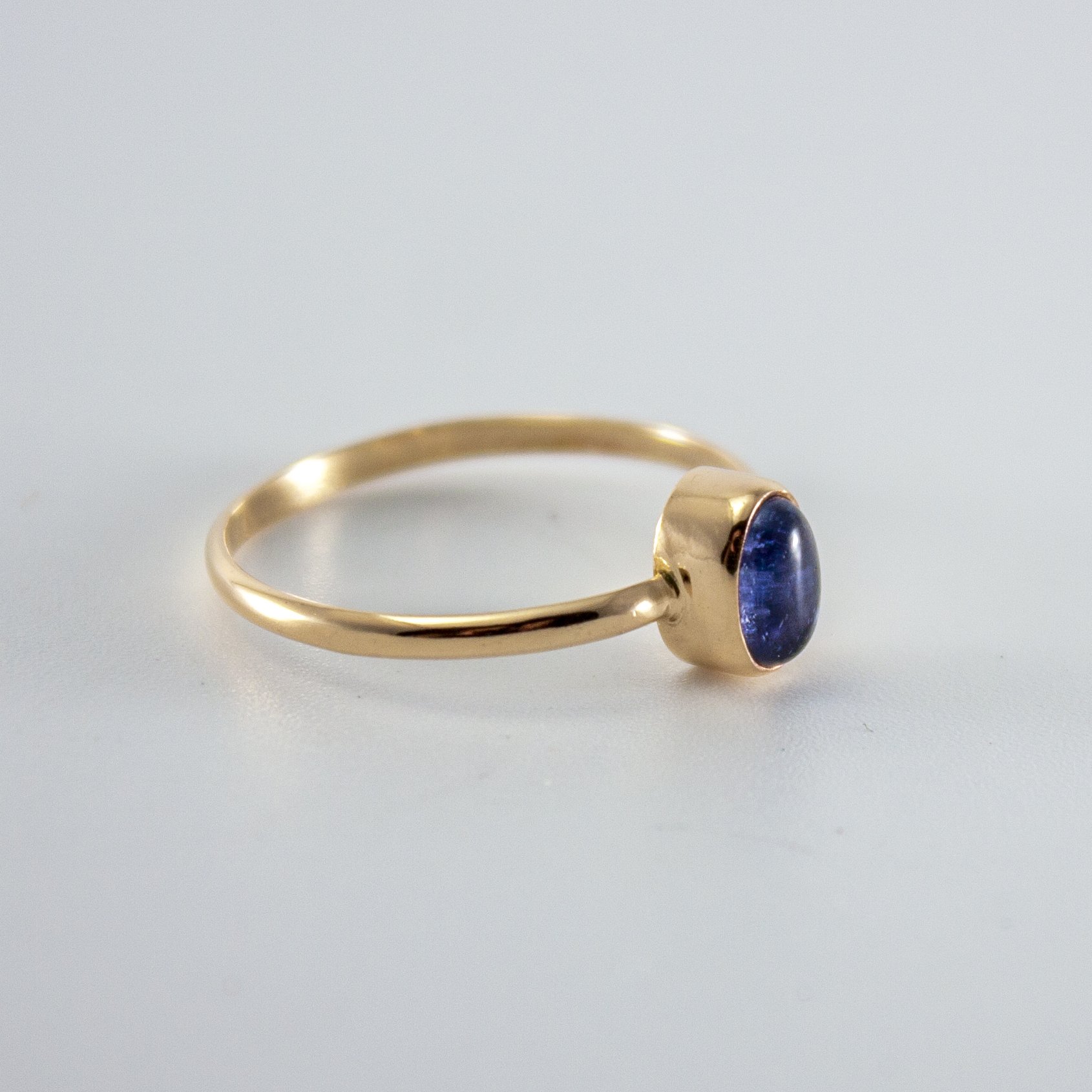 Iolite Oval Step Bezel Ring in 14k gold filled, showcasing a violet gemstone in a minimalist design.