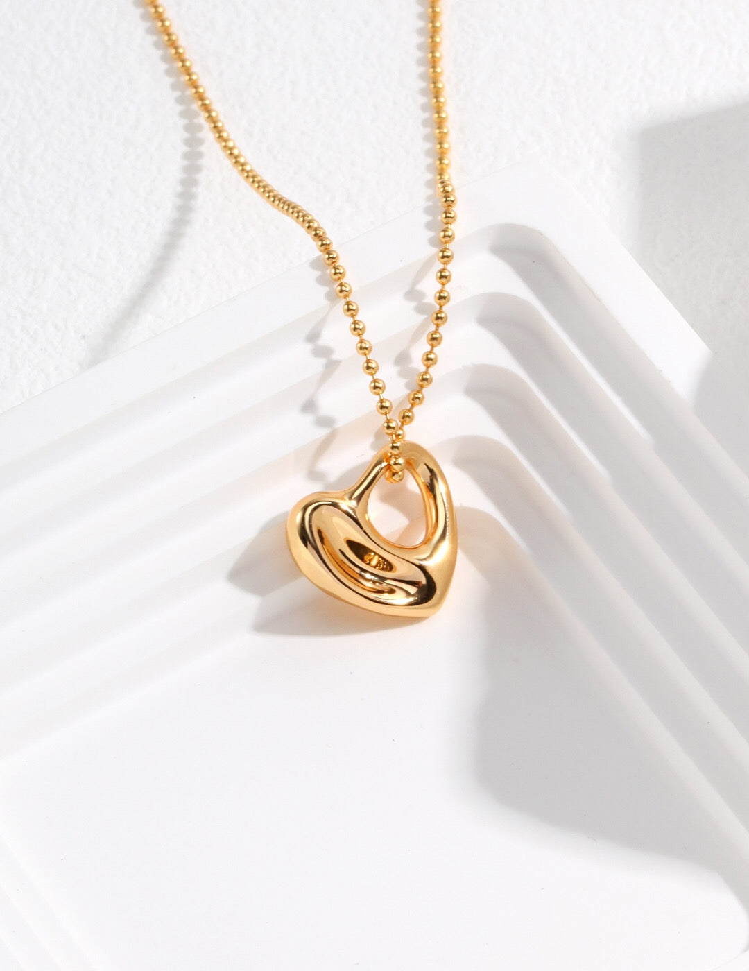 A stunning Irregular Hollow Heart Necklace made of gold vermeil, featuring a unique design and adjustable chain.