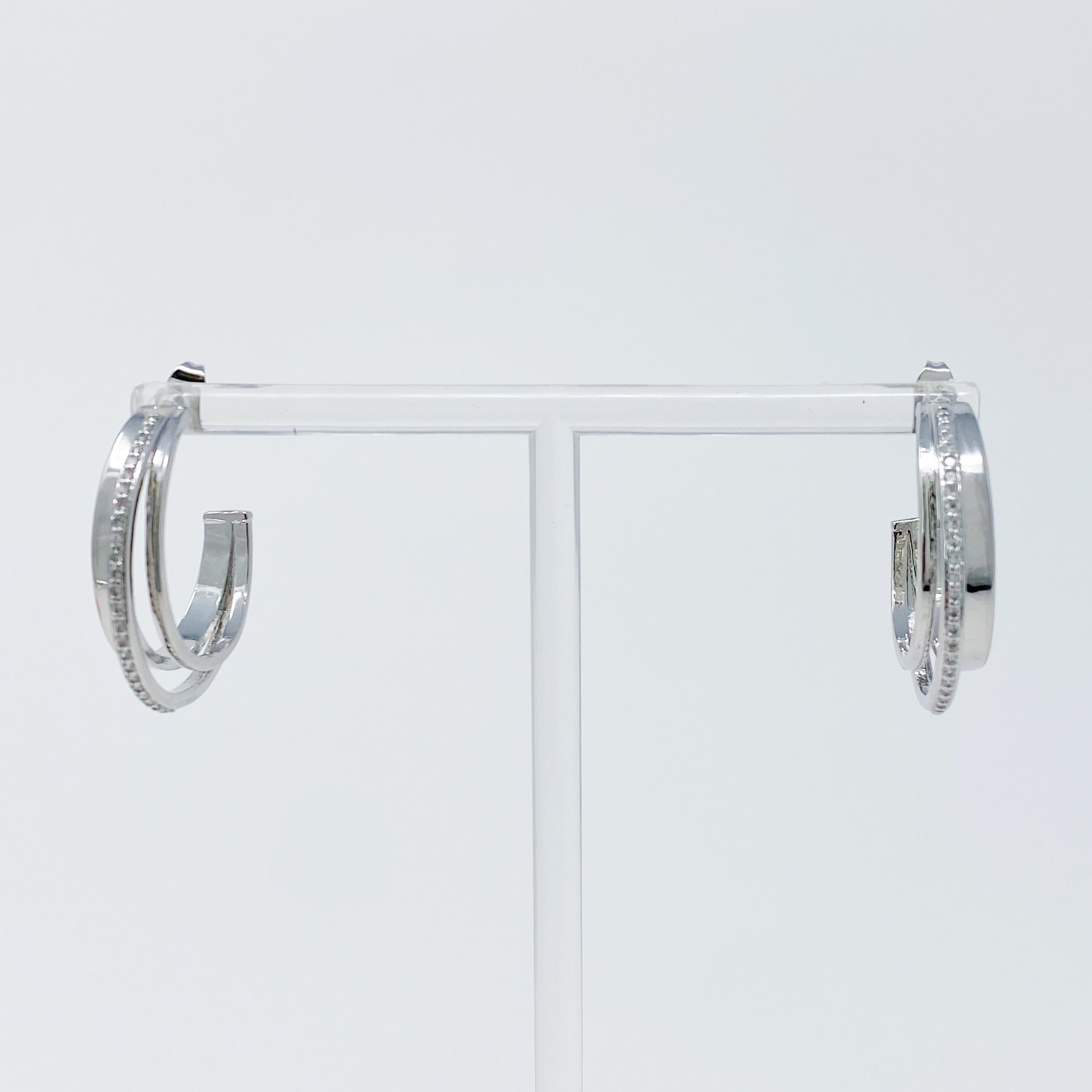 Irene Dimensional Hoop Earrings featuring three layered hoops in 18k Gold or Rhodium plating with sparkling Cubic Zirconia.