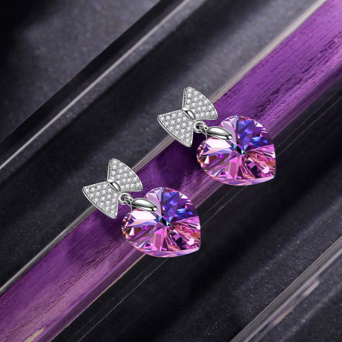 Iridescent Amethyst Heart Shaped Bow-Tie Earrings featuring 18K white gold plating and a stunning purple gemstone.