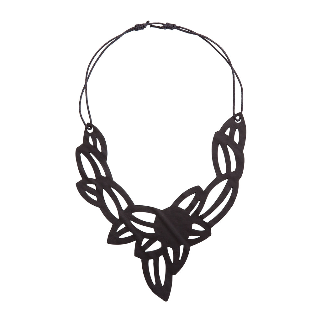 Iris Elegant Inner Tube Vegan Necklace showcasing unique patterns and textures, handcrafted from recycled rubber with a cotton cord.