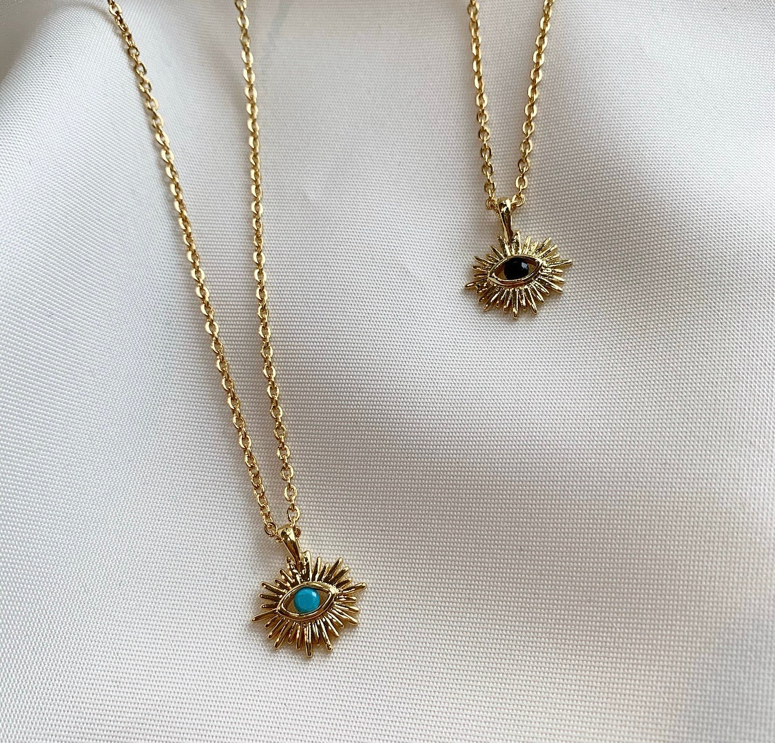 IRIS Necklace featuring an evil eye design with sun rays and a cubic zirconia stone, elegantly plated in 18K gold.