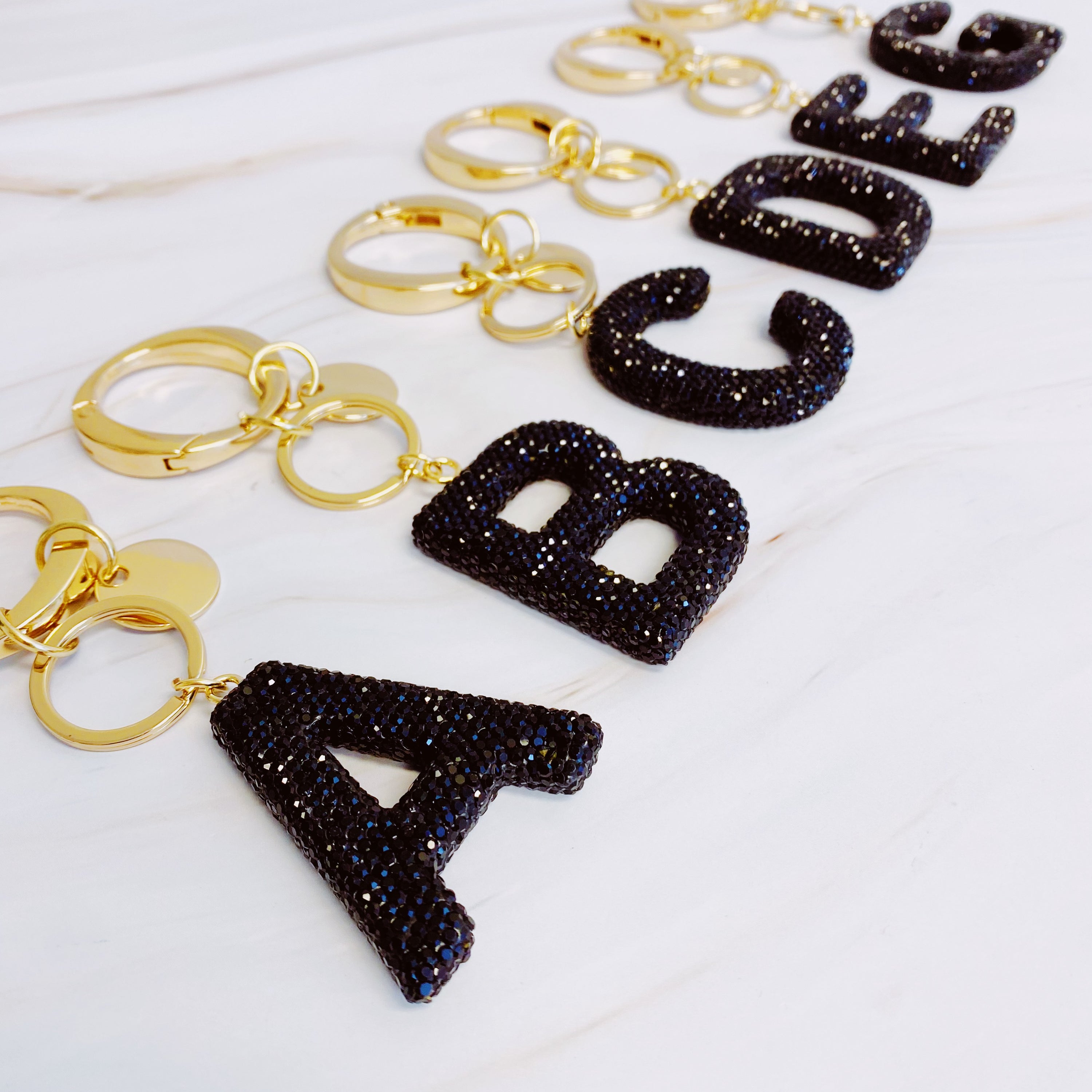 It Girl Glam Initial Key Chain featuring a stylish initial design, perfect for personal expression and gifting.