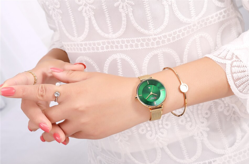 Jade Curren Women Watch featuring an emerald green dial and a luxurious gold textured band, showcasing elegance and sophistication.