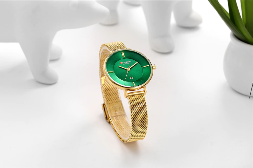 Jade Curren Women Watch featuring an emerald green dial and a luxurious gold textured band, showcasing elegance and sophistication.