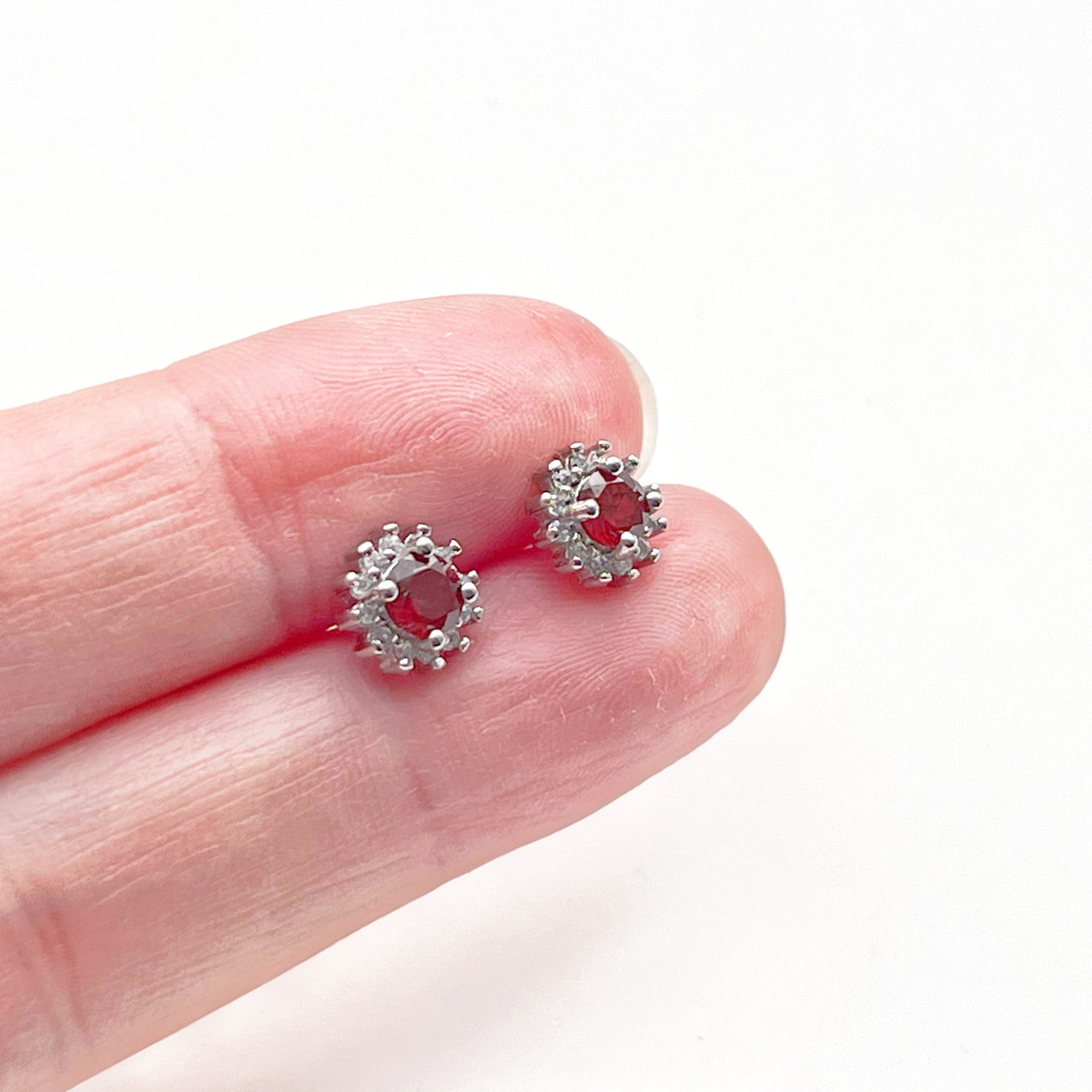 A pair of elegant garnet silver stud earrings featuring natural red garnet stones set in hypoallergenic sterling silver.