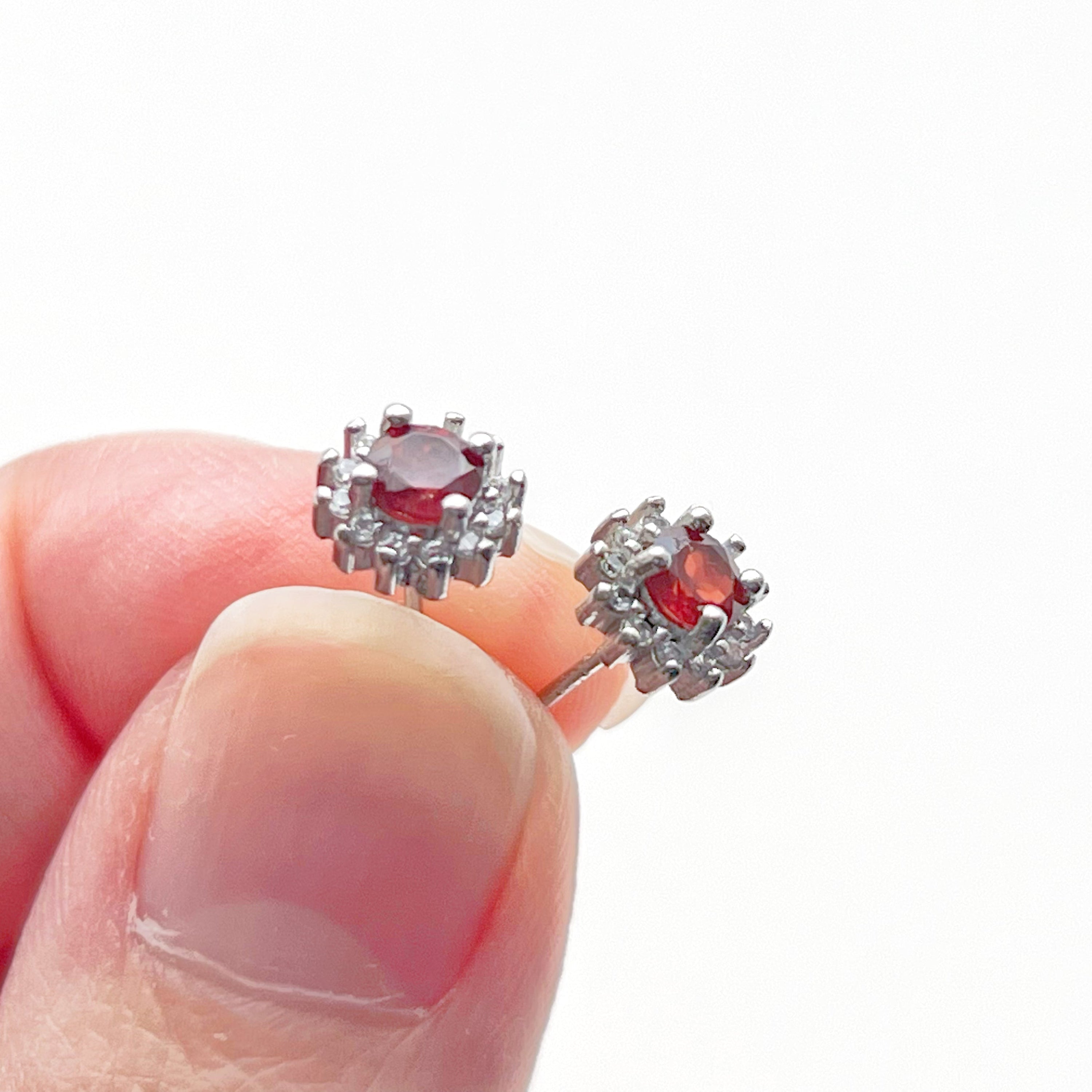 A pair of elegant garnet silver stud earrings featuring natural red garnet stones set in hypoallergenic sterling silver.