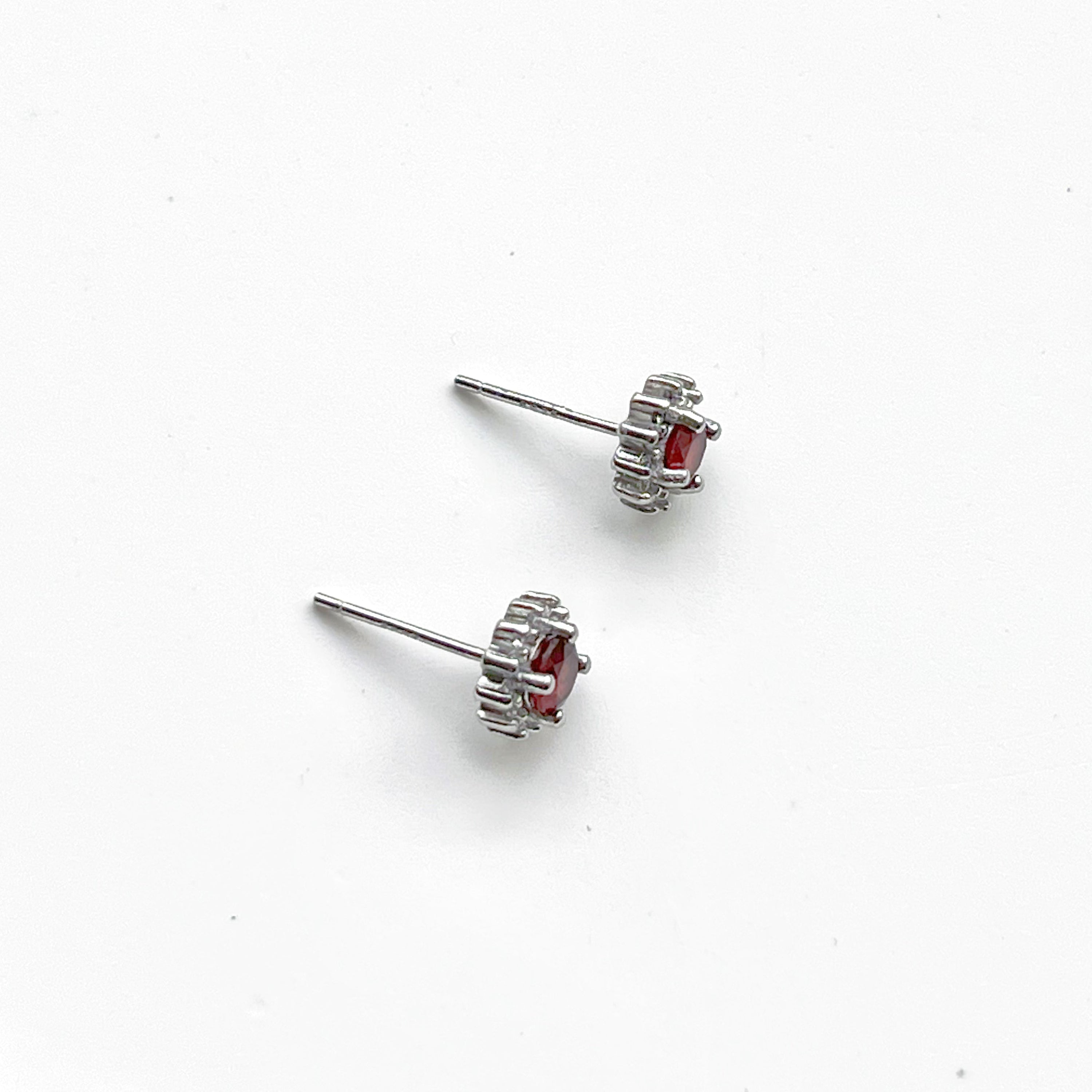 A pair of elegant garnet silver stud earrings featuring natural red garnet stones set in hypoallergenic sterling silver.