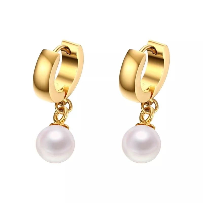 Jax Pearl Huggie earrings featuring a pearl and gold design, elegantly crafted for versatile styling.