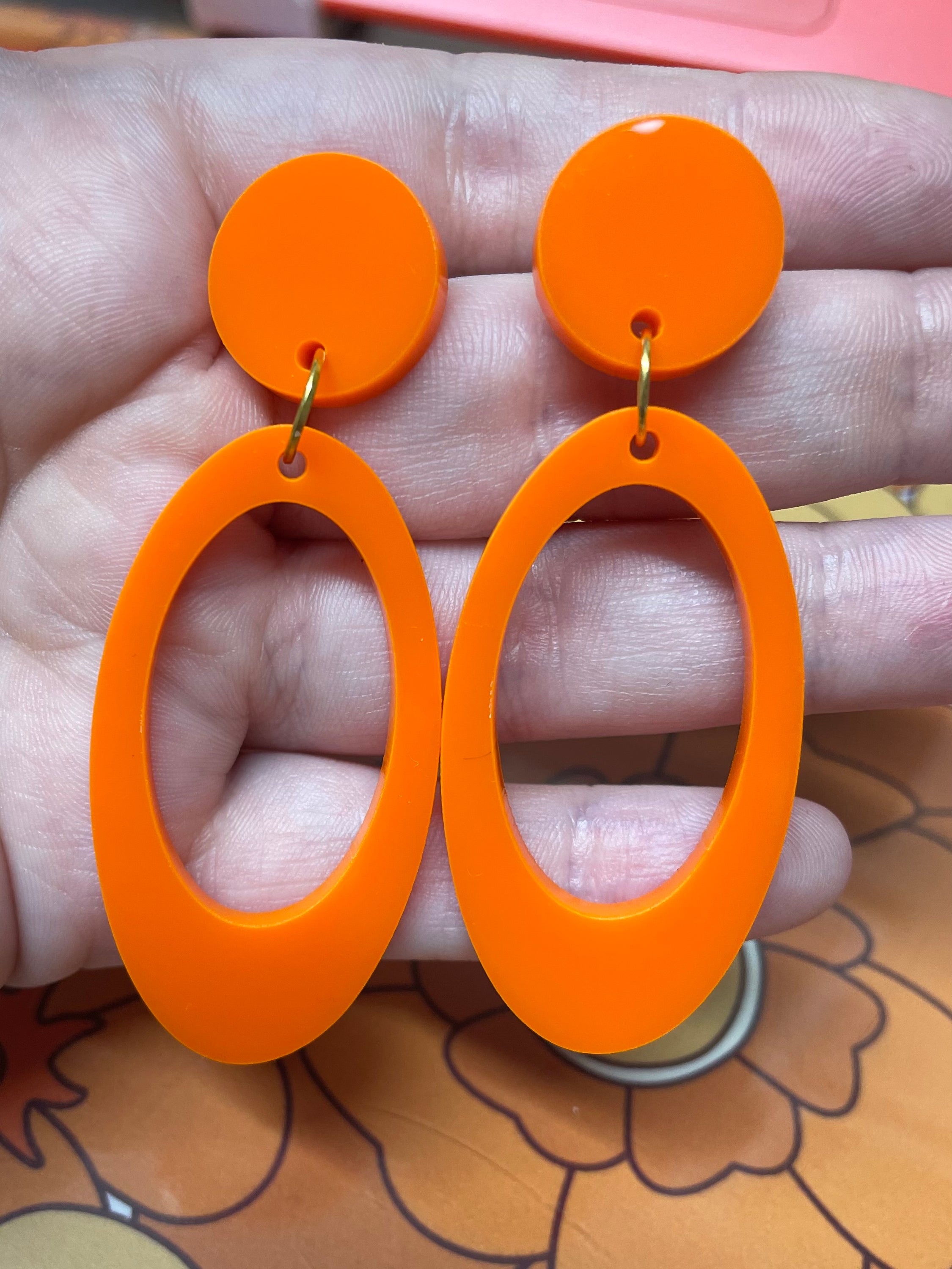 Jerry Earrings featuring laser-cut acrylic design, approximately 6.75cm in height and 2.75cm in width, available in clip-on style.