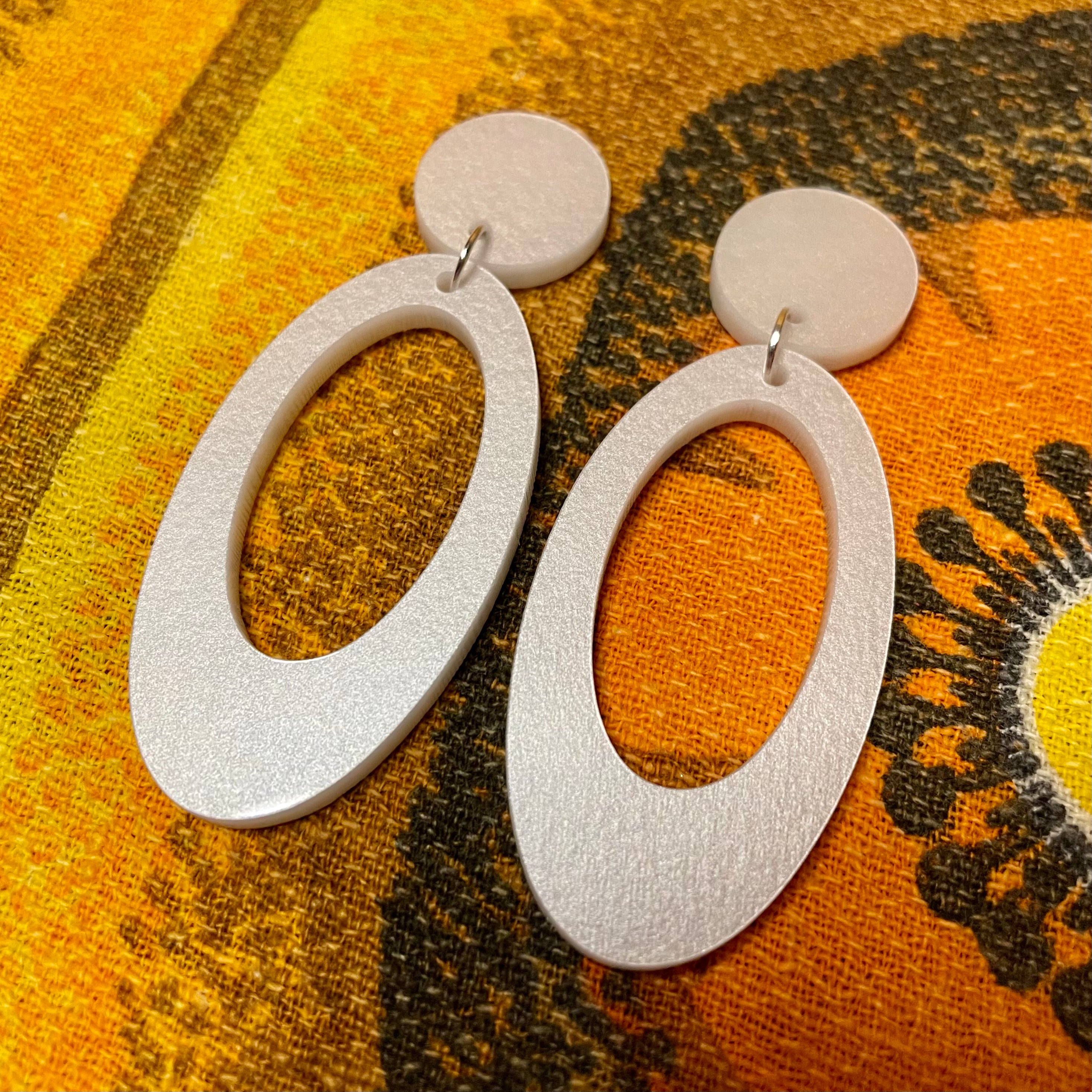 Jerry Earrings featuring laser-cut acrylic design, approximately 6.75cm in height and 2.75cm in width, available in clip-on style.