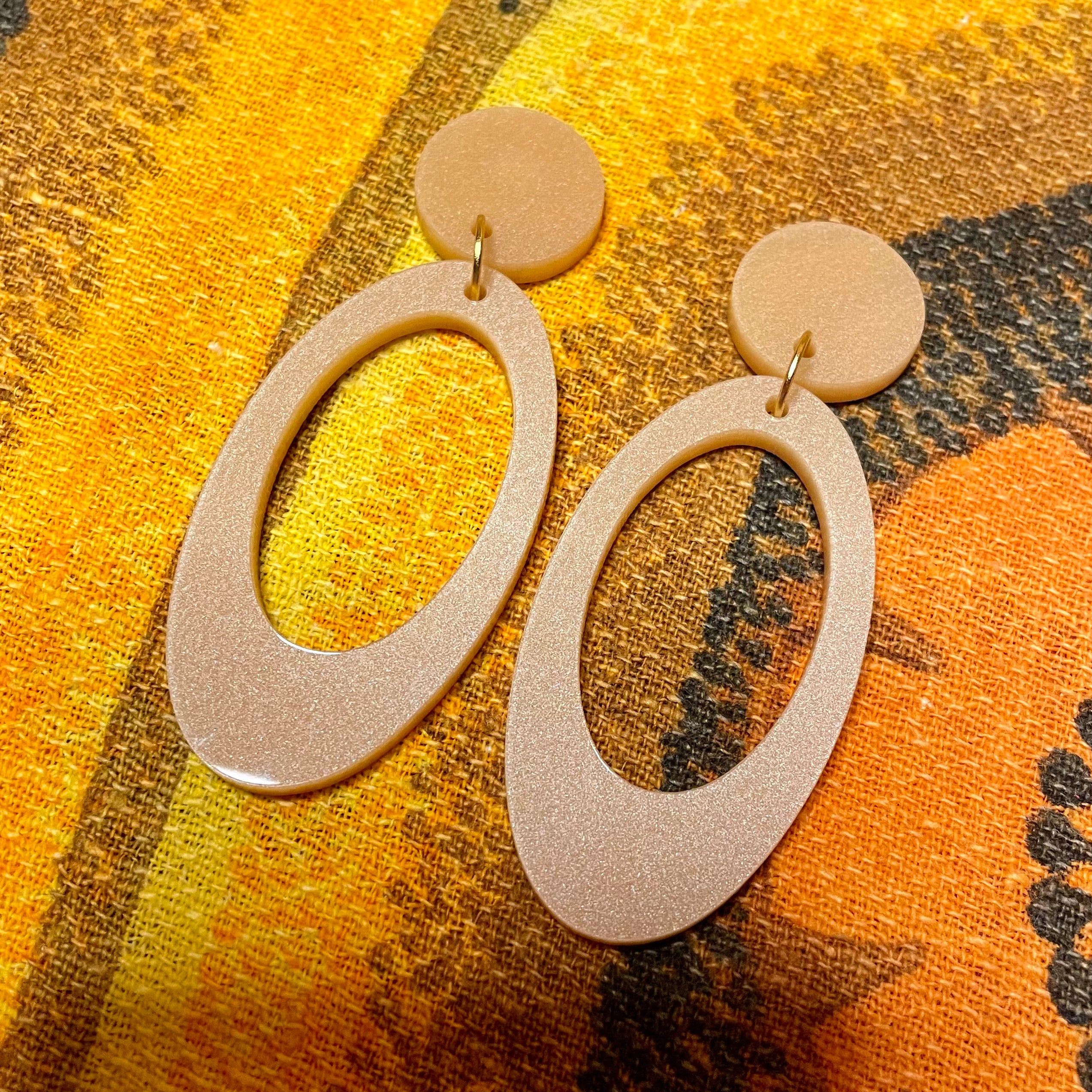 Jerry Earrings featuring laser-cut acrylic design, approximately 6.75cm in height and 2.75cm in width, available in clip-on style.