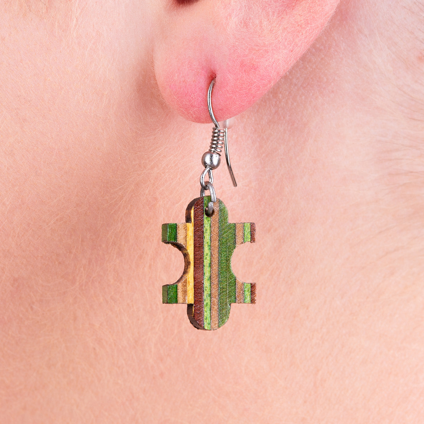 Colorful Jigsaw Recycled Skateboard Earrings handcrafted from salvaged skateboards, featuring unique patterns and lightweight design.