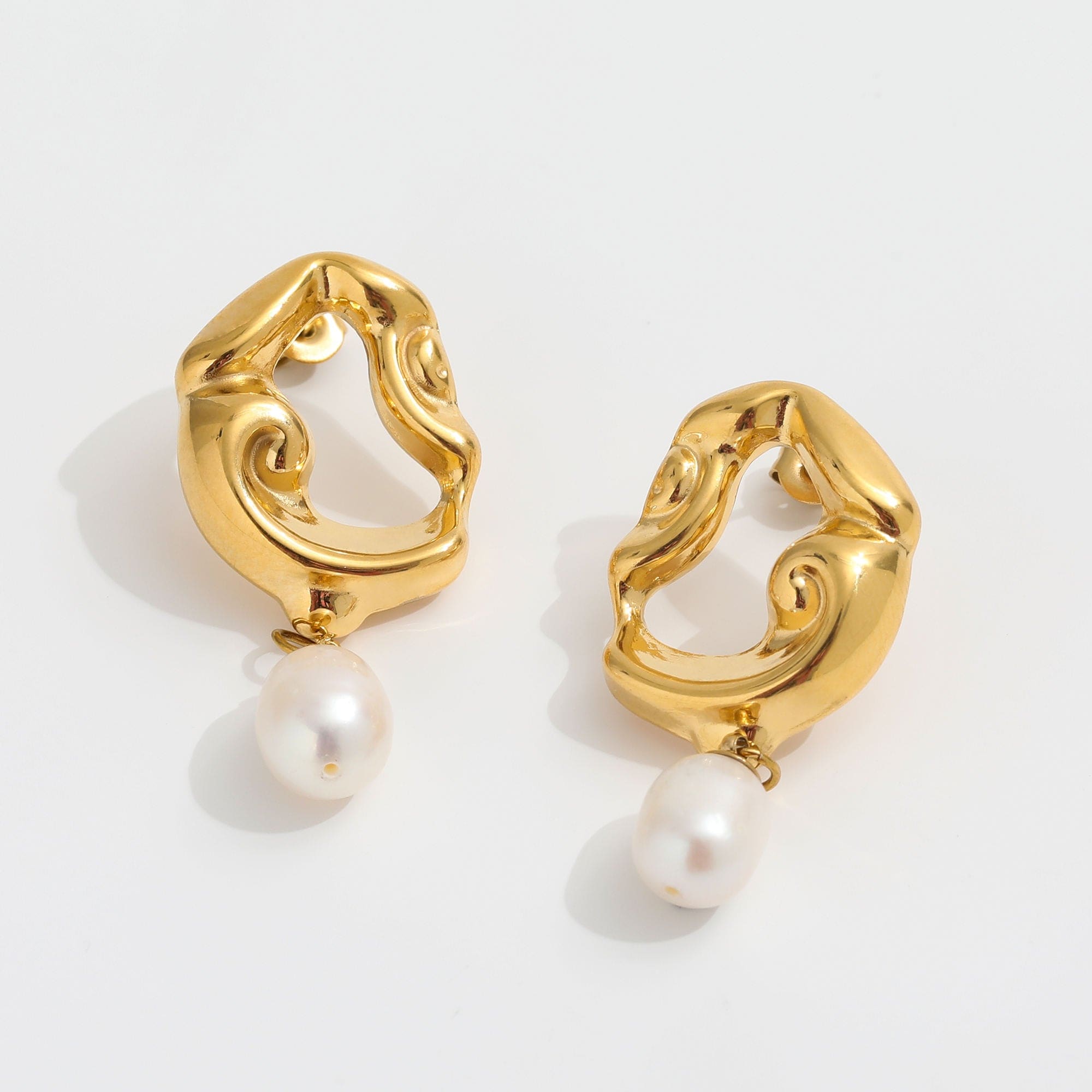 Jove gold hoops featuring baroque studs and dangling freshwater pearl drops, elegantly designed for a whimsical look.