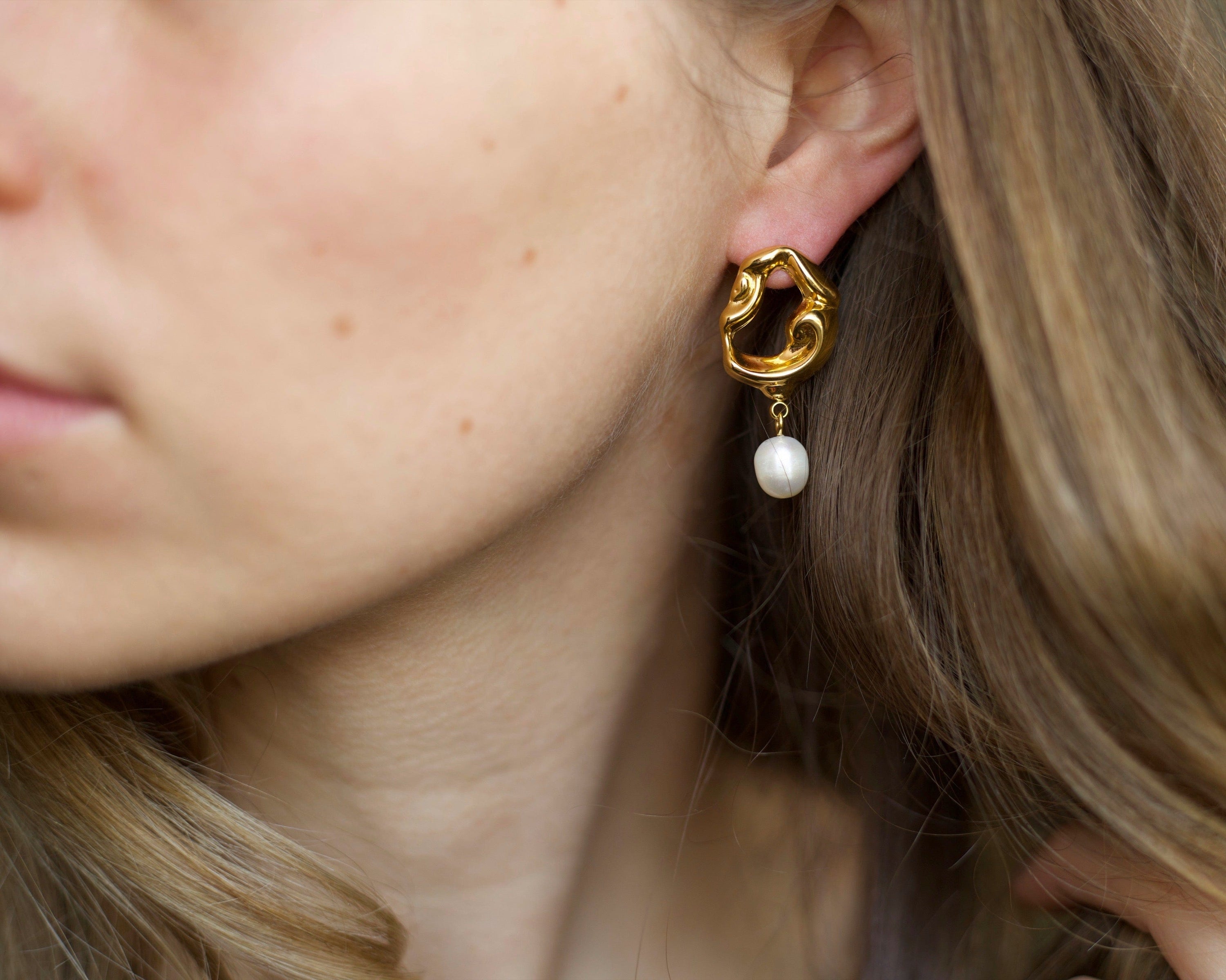 Jove gold hoops featuring baroque studs and dangling freshwater pearl drops, elegantly designed for a whimsical look.