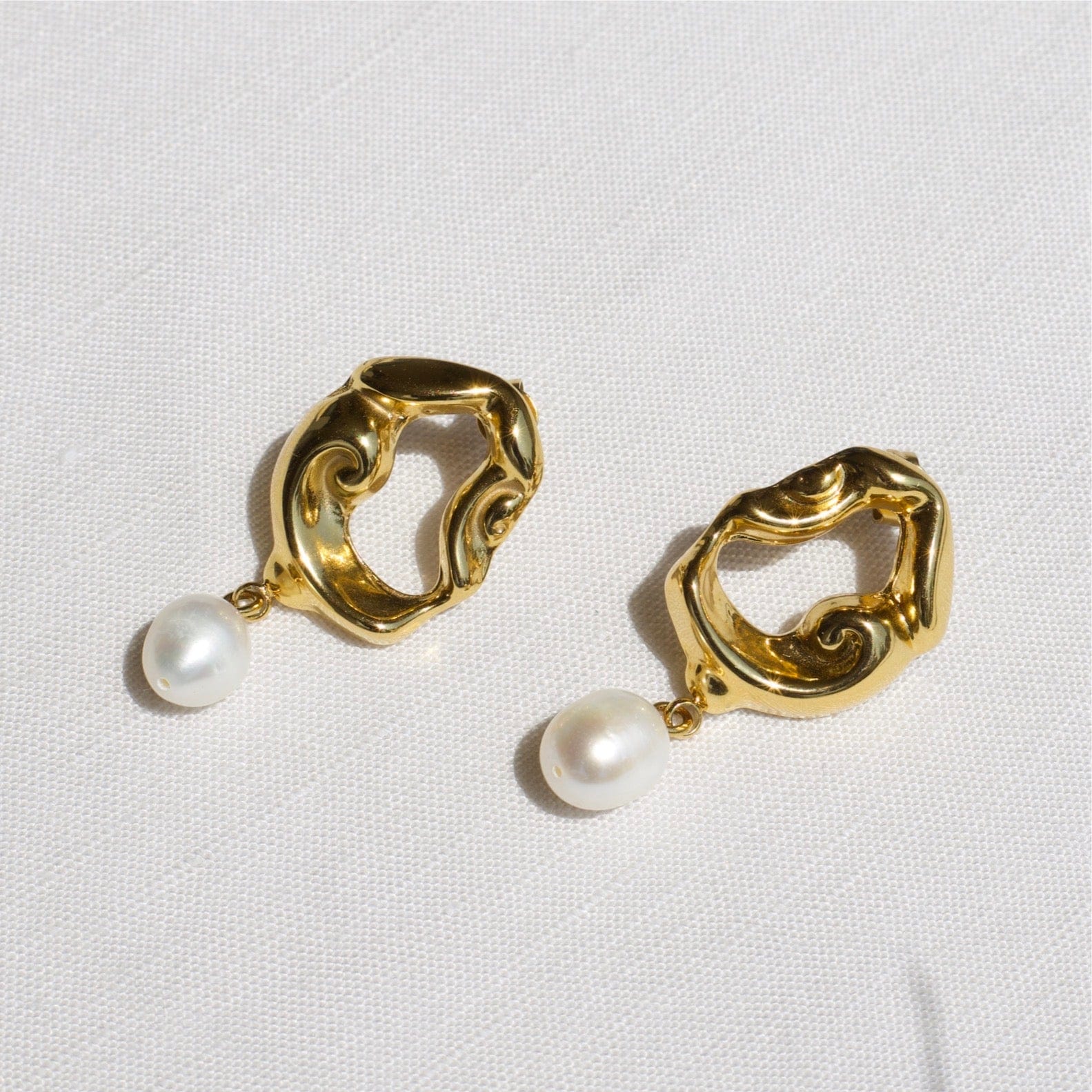 Jove gold hoops featuring baroque studs and dangling freshwater pearl drops, elegantly designed for a whimsical look.