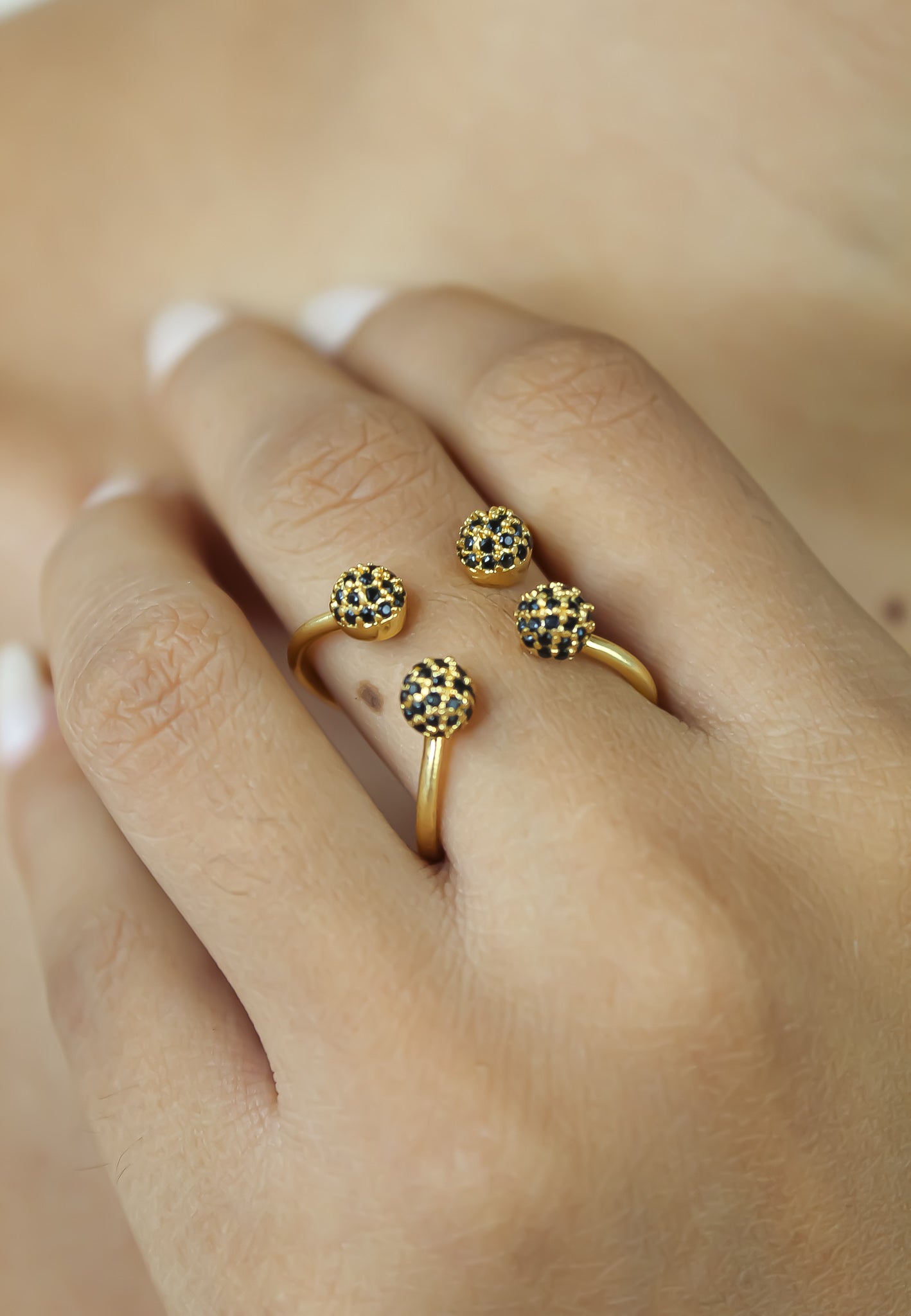 Joy Ring featuring 18K gold plating and adjustable design, elegantly displayed against a soft background.