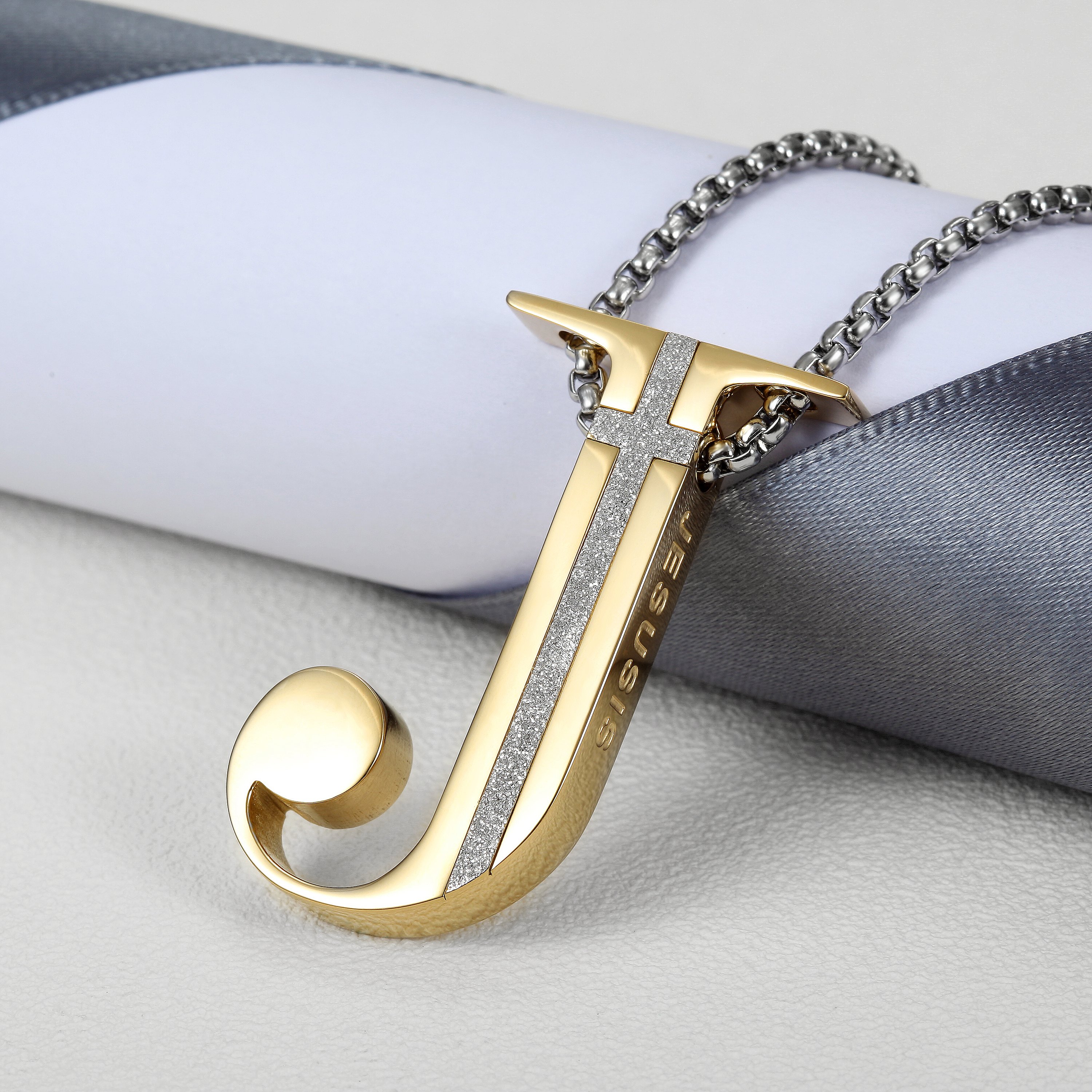 Elegant J-shaped pendant necklace made of 316L surgical stainless steel with 14K gold PVD plating.