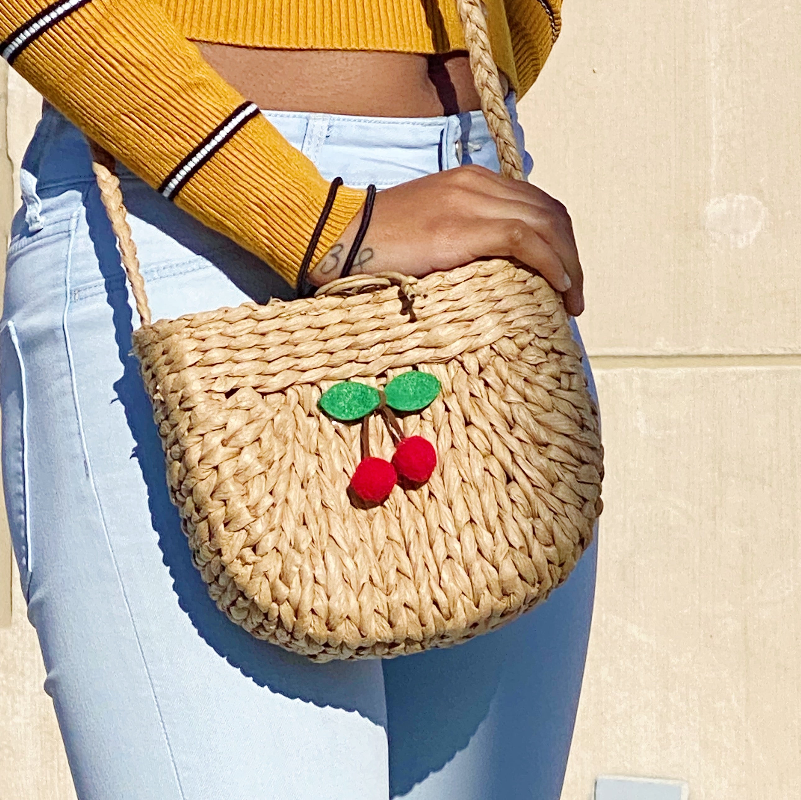 Juicy Bloom Straw Crossbody Bag with embroidered design, showcasing its stylish and functional features.