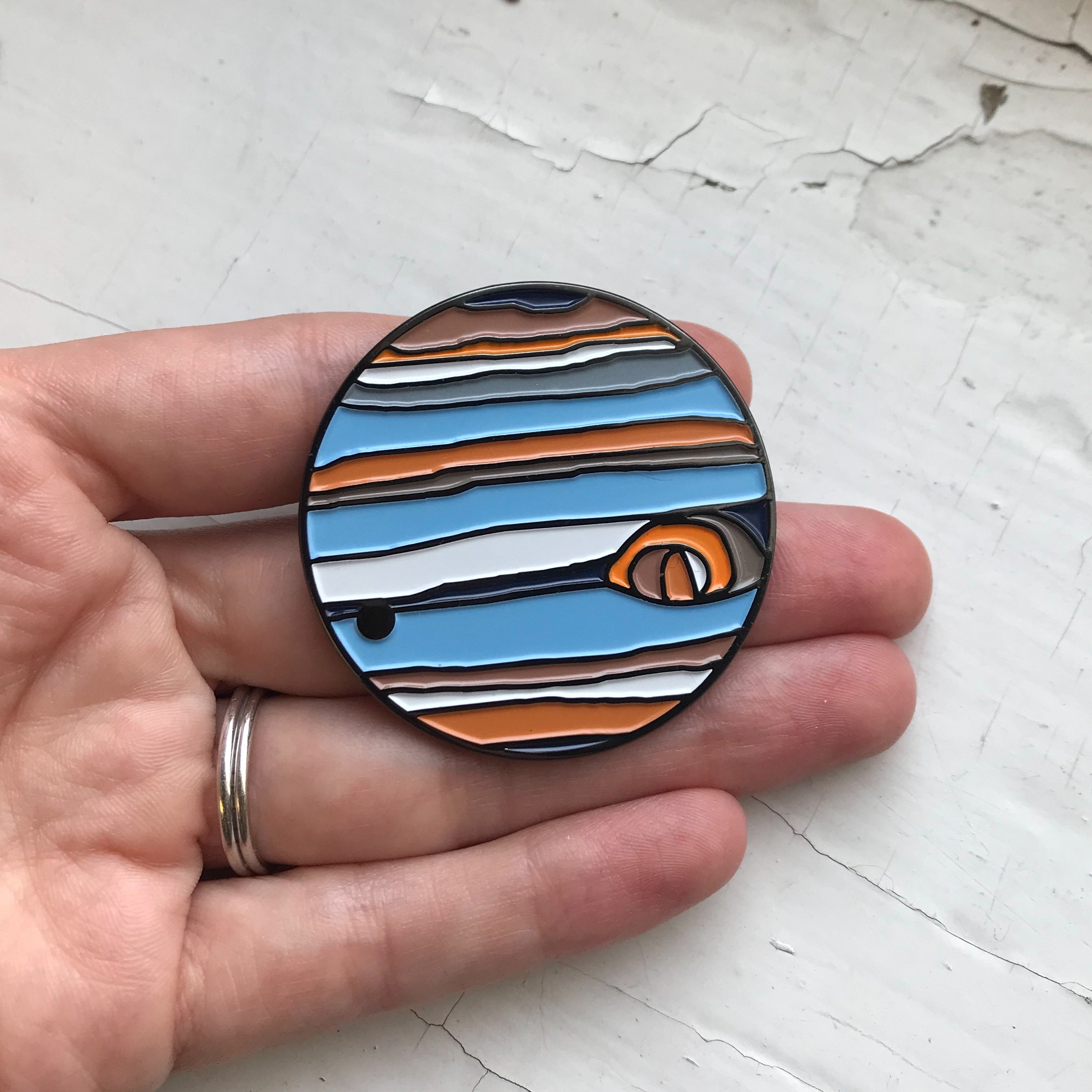 Jupiter Enamel Pin featuring a vibrant design of the gas giant, perfect for jackets and backpacks.