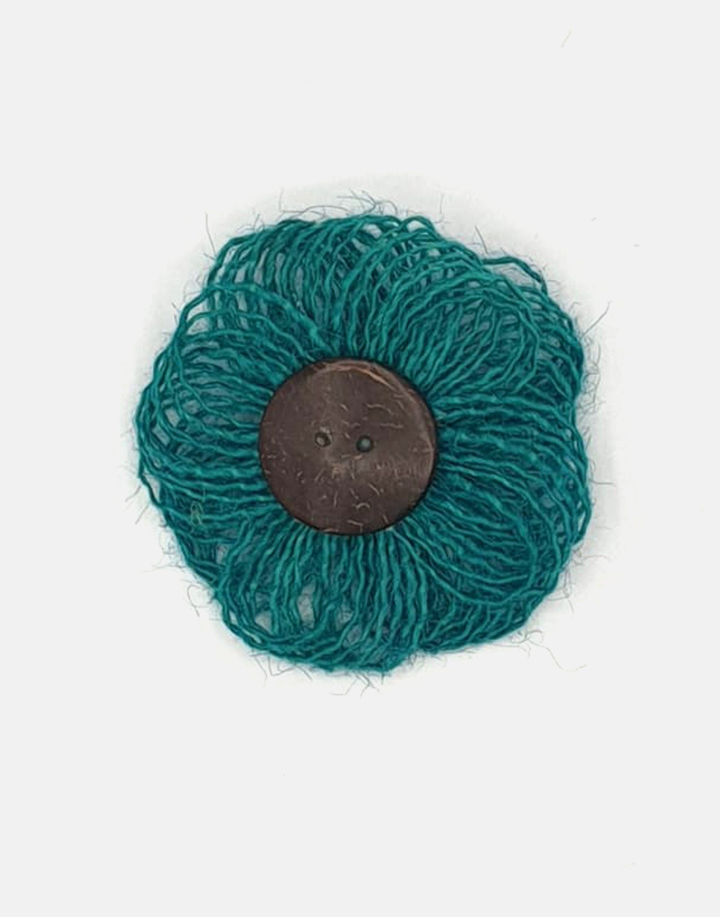 A delicate jute flower brooch featuring a coconut button at the center, showcasing natural fibers and a charming design.