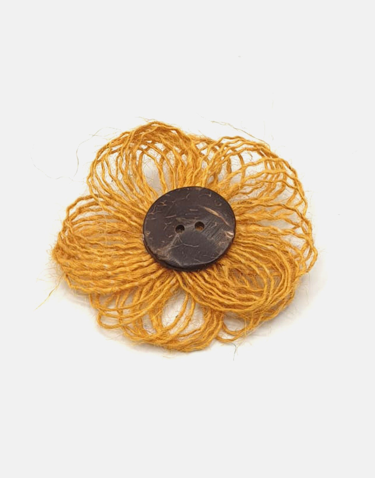 A delicate jute flower brooch featuring a coconut button at the center, showcasing natural fibers and a charming design.