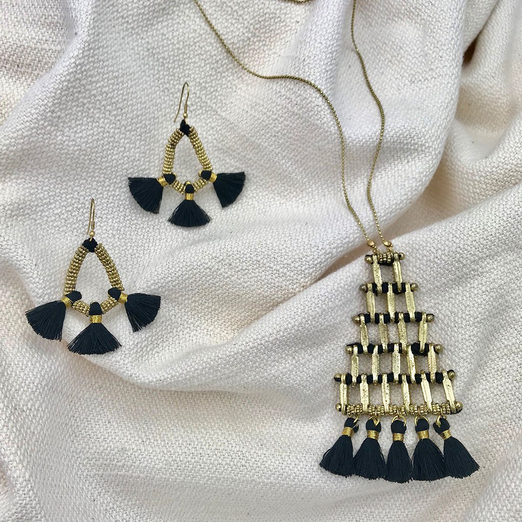 A stylish Kai Pyramid Necklace featuring a bold pyramid pendant, crafted from zinc alloy and cotton tassels, perfect for any outfit.