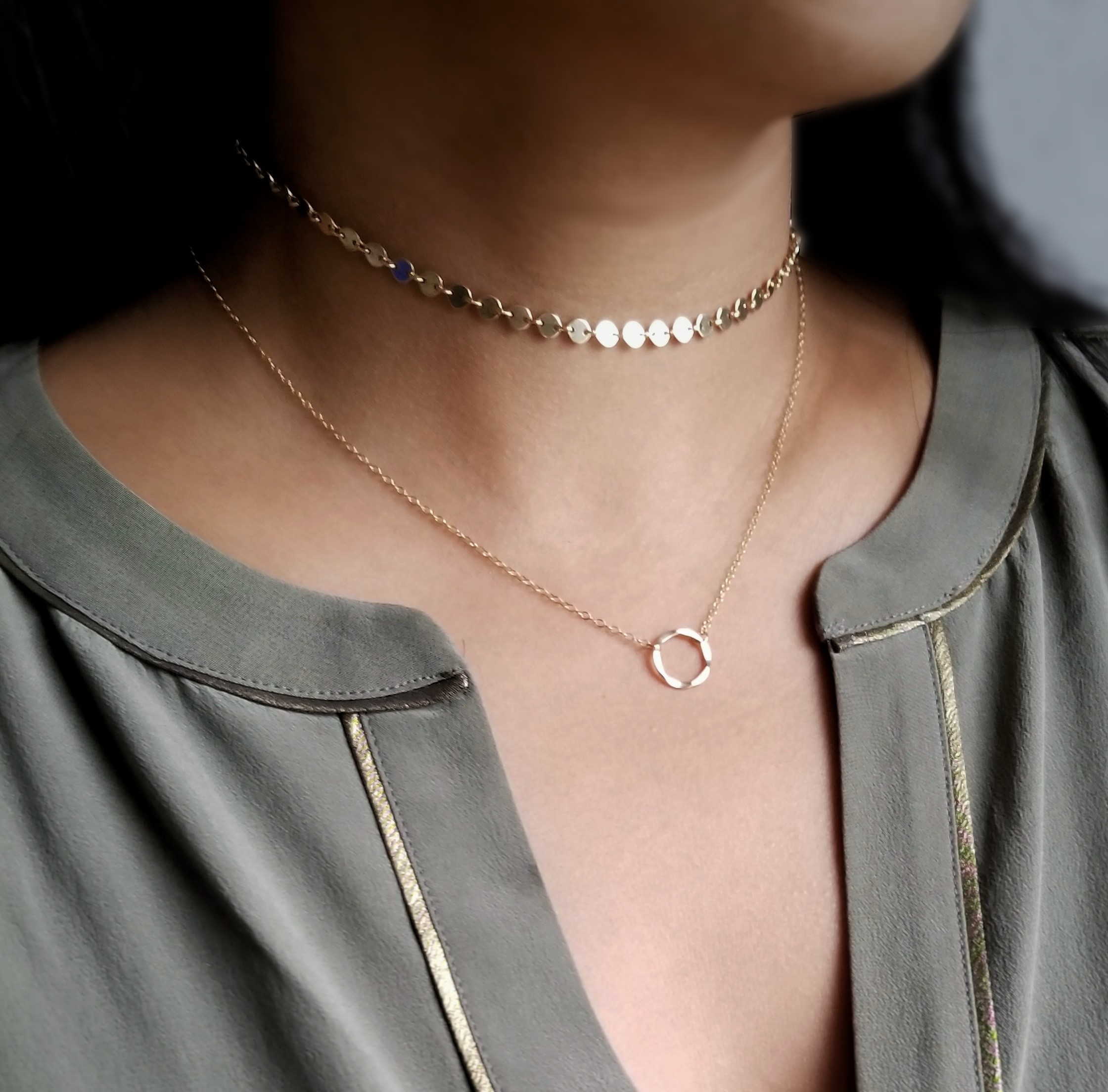 Karma Necklace featuring a hammered circle pendant on a gold or silver chain, symbolizing positivity and interconnectedness.