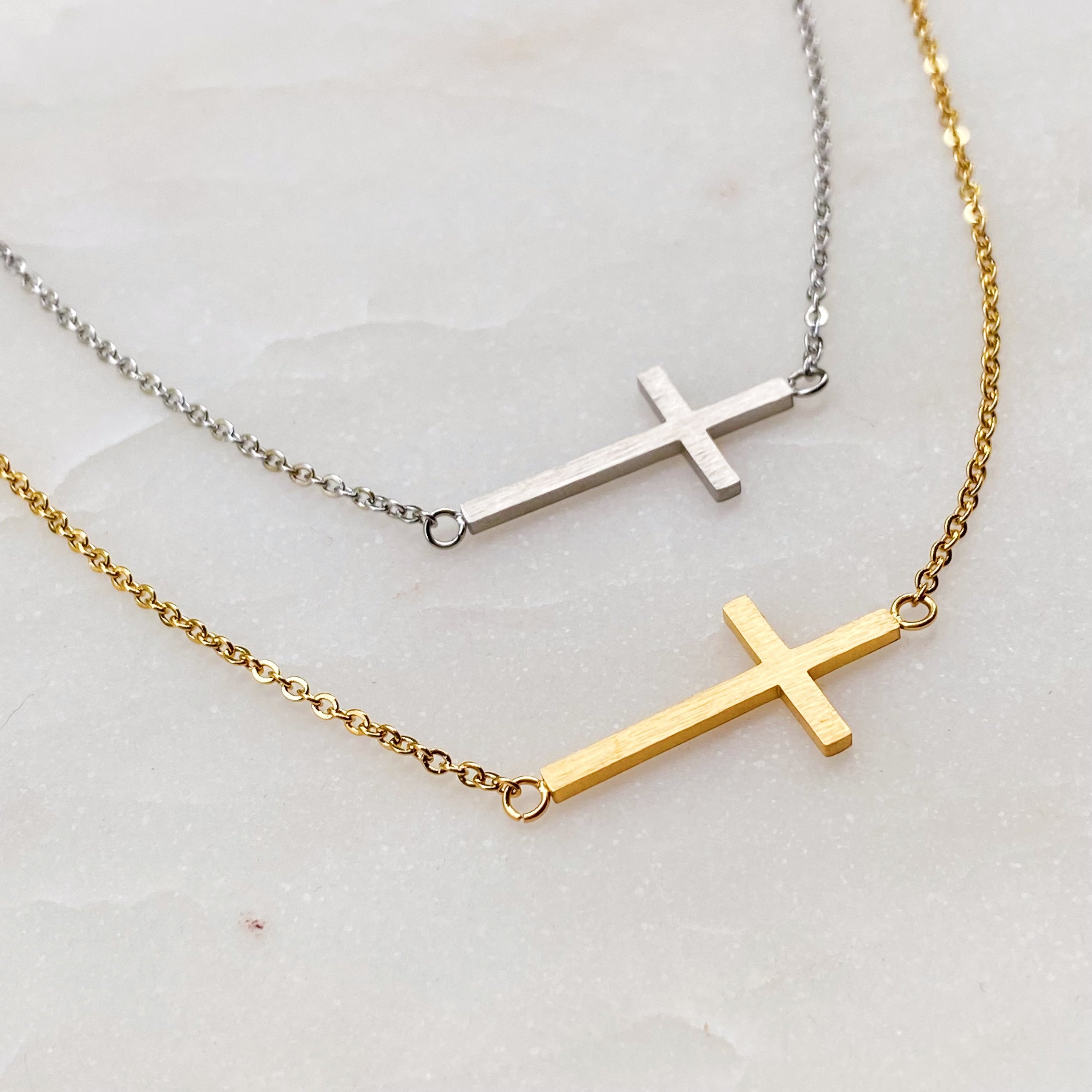 Kayla Cross Necklace featuring a side hanging cross design on a 16-inch chain, elegantly plated in 18K gold.