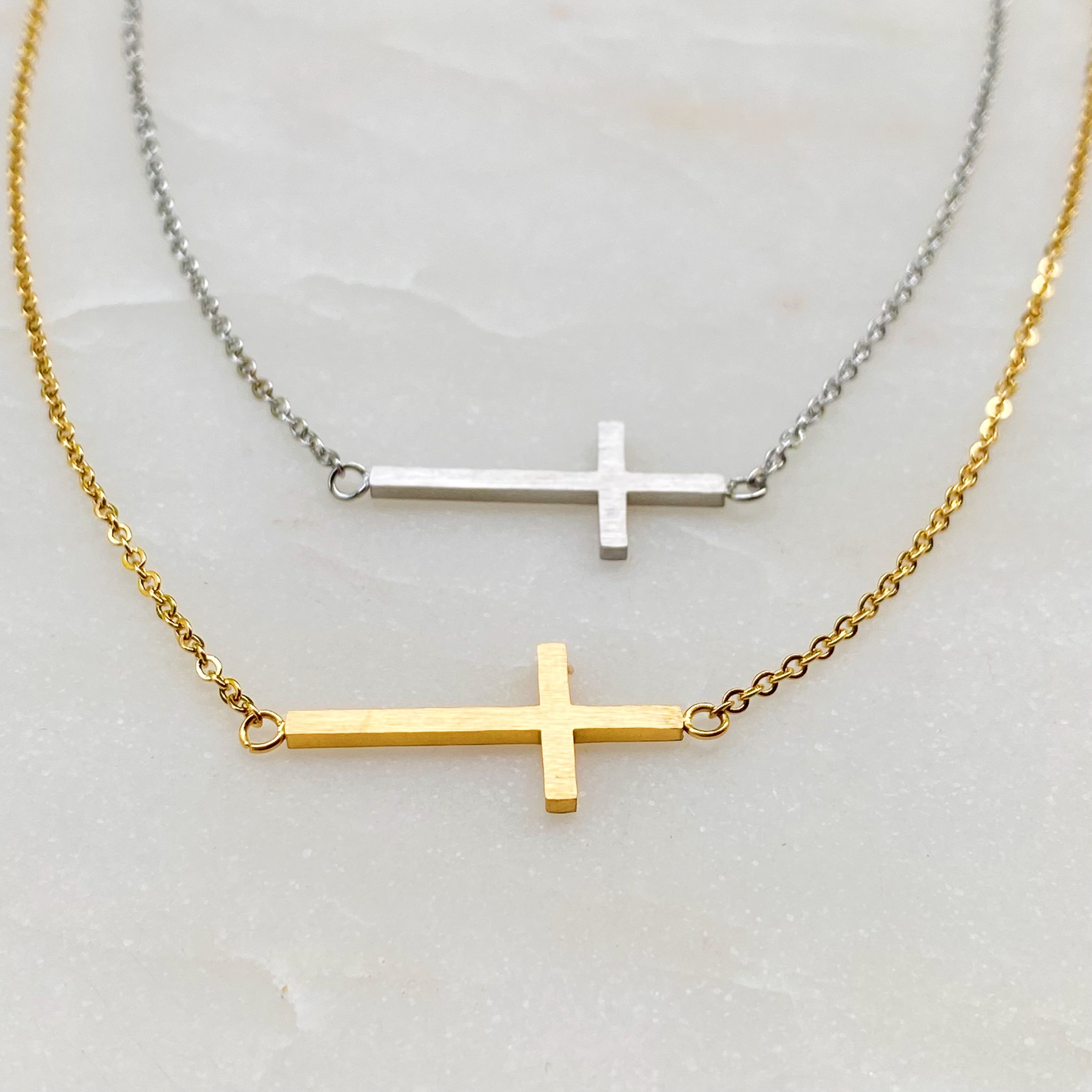 Kayla Cross Necklace featuring a side hanging cross design on a 16-inch chain, elegantly plated in 18K gold.