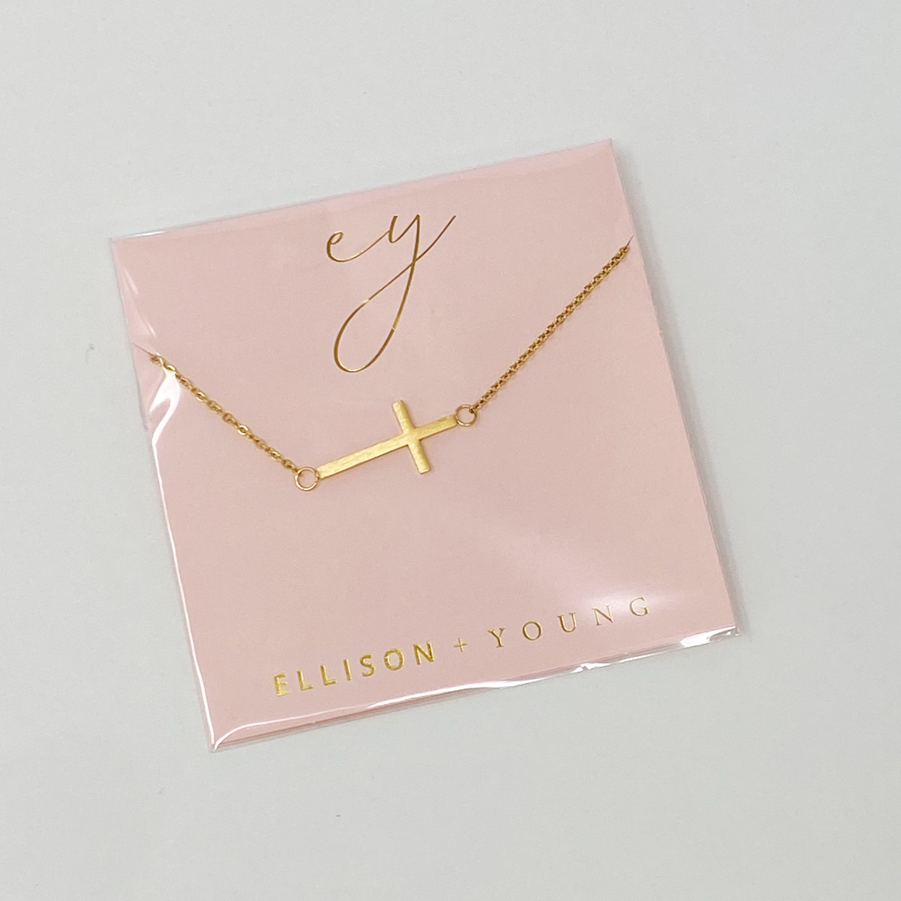 Kayla Cross Necklace featuring a side hanging cross design on a 16-inch chain, elegantly plated in 18K gold.