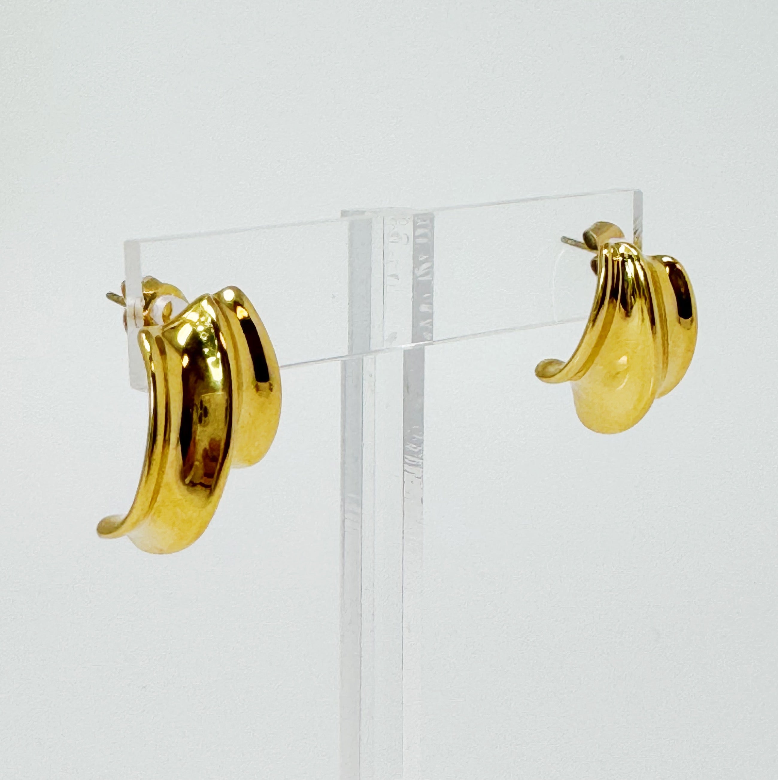 A pair of Kelly Golden Hoop Earrings made from 18k gold plated stainless steel, showcasing a modern and chic design.