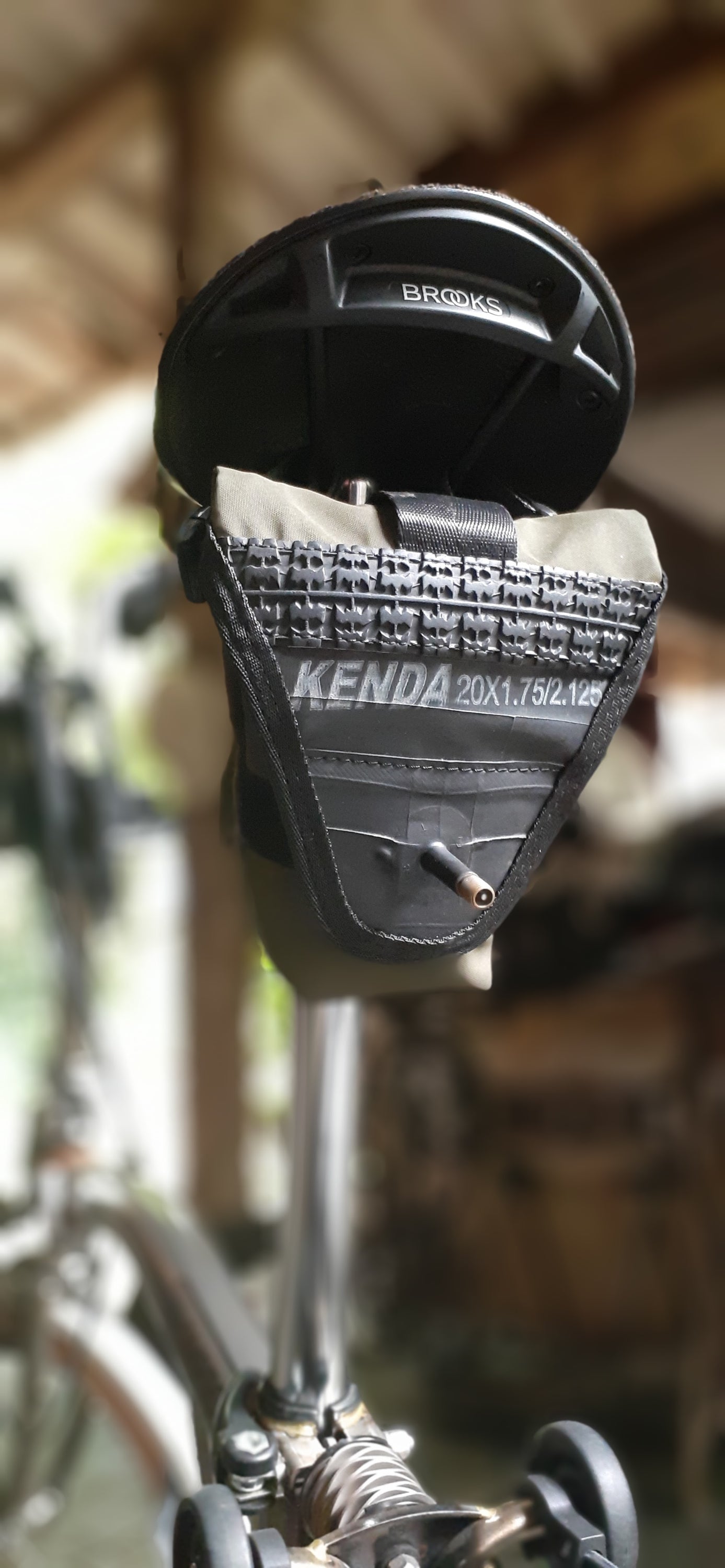 Kenny Eco Bike Saddle Bag made from reclaimed materials, featuring adjustable straps and a water-resistant design.