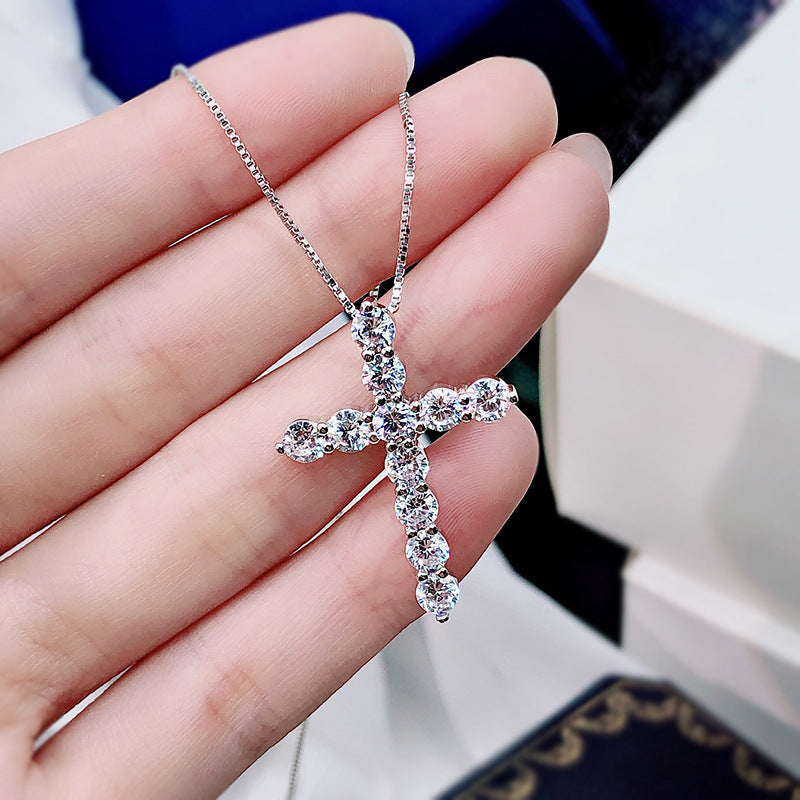 A stunning cross necklace made of 925 sterling silver, featuring a polished finish and adorned with sparkling cubic zirconia stones.