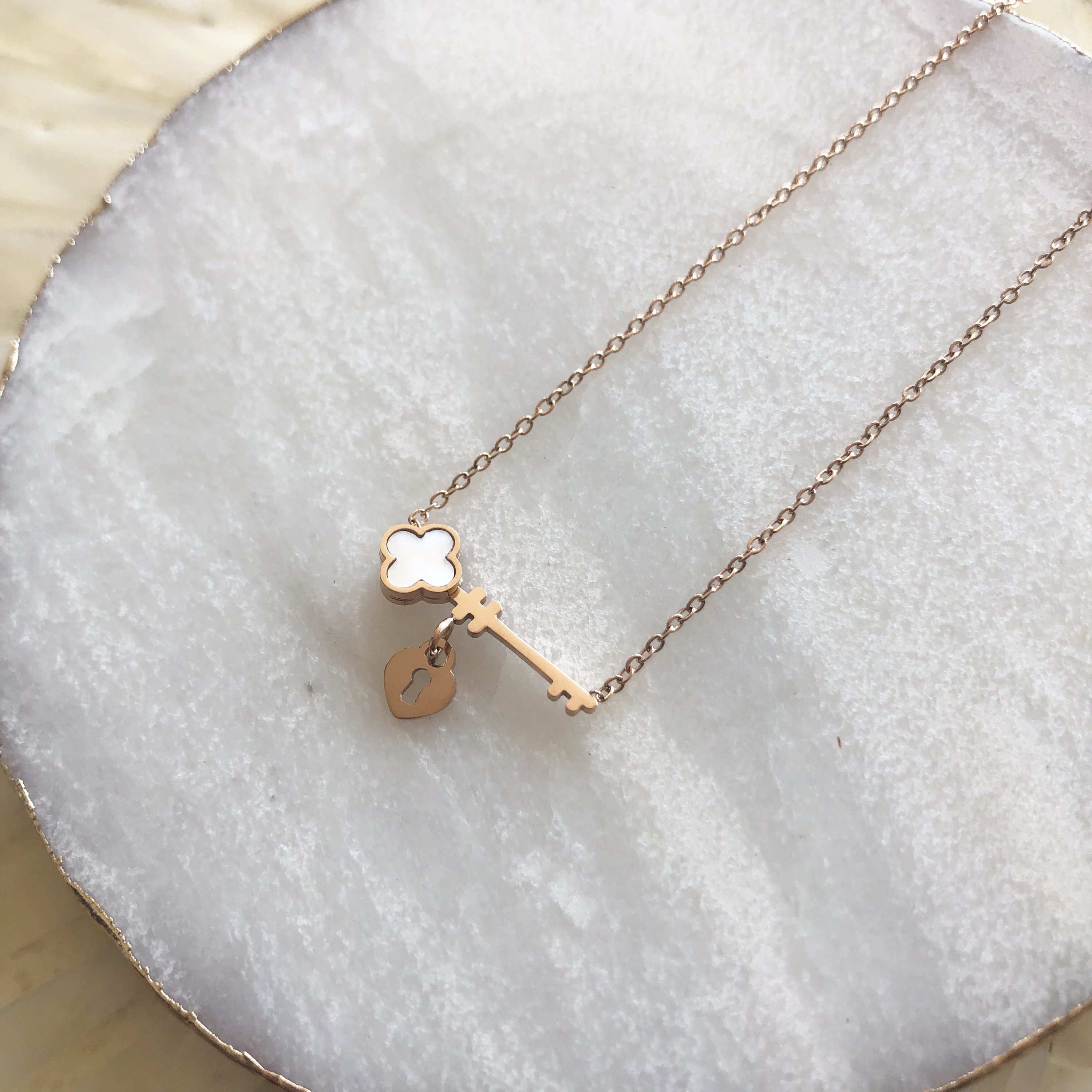 Key to My Heart Necklace in rose gold, silver, and gold finishes with a tiny opal clover accent.