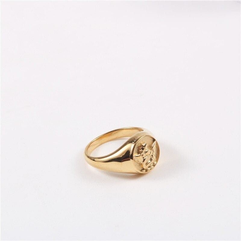 Kiki Carved Angel Baby Signet Ring showcasing a chunky gold and silver design with a carved angel motif.