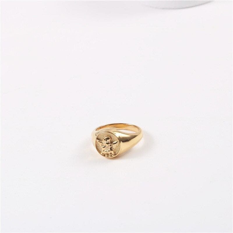 Kiki Carved Angel Baby Signet Ring showcasing a chunky gold and silver design with a carved angel motif.