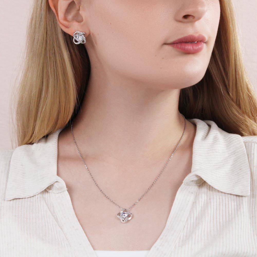 Knot Of Love Necklace featuring a Love Knot design in 14k white gold over stainless steel with a sparkling cubic zirconia stone.