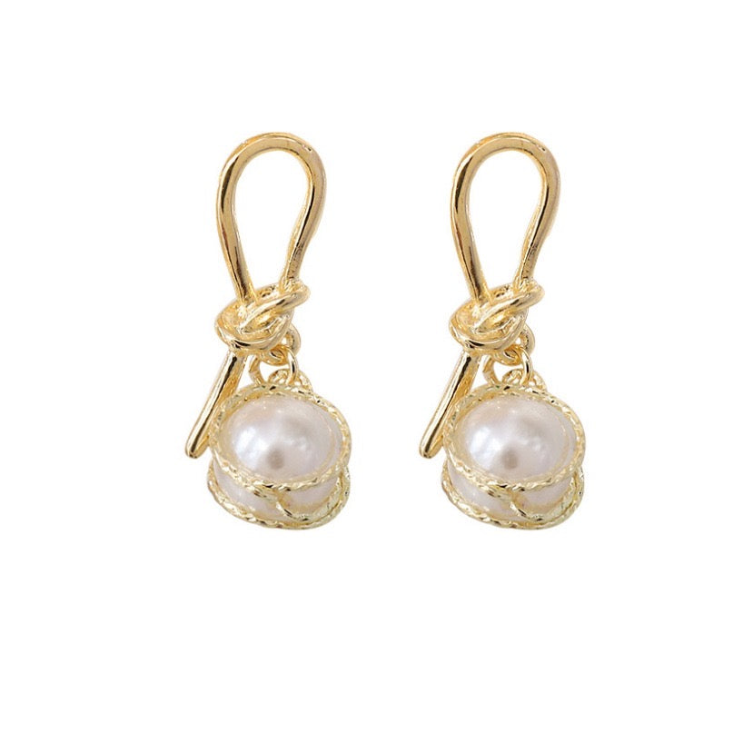 Elegant knotted gold wired earrings featuring a single artificial pearl, perfect for stylish occasions.