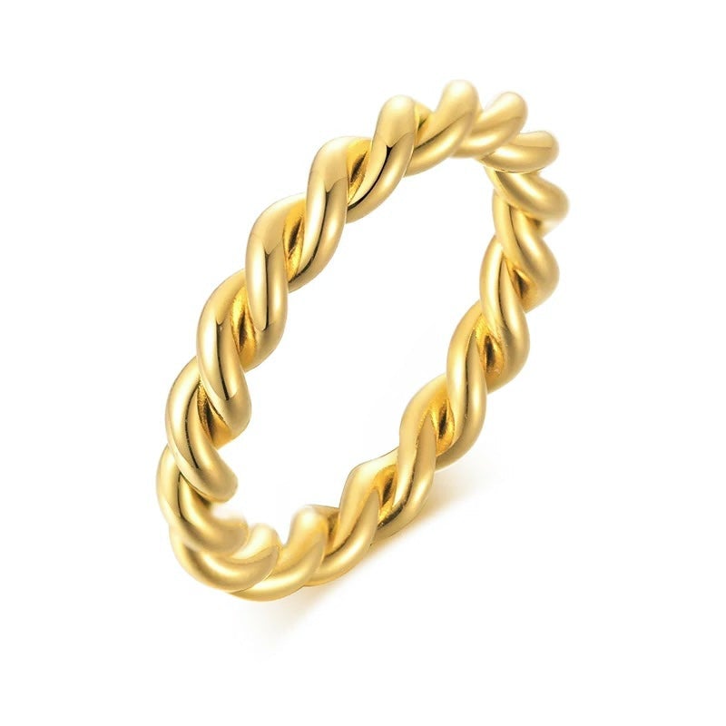 Lana Twist Ring featuring an elegant twist design, 18k gold plated over stainless steel, showcasing its luxurious finish.