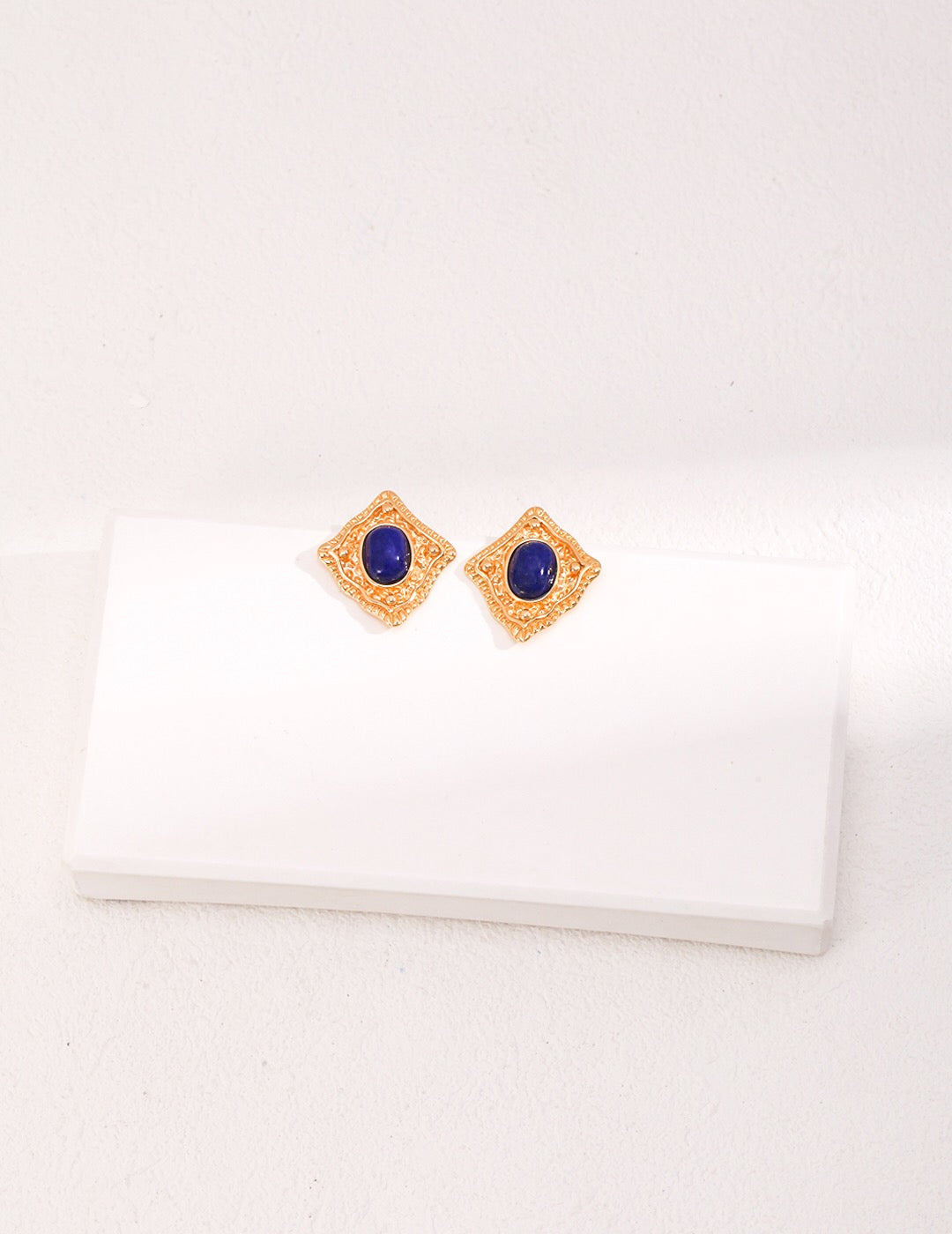 Handmade Lapis Lazuli and Carnelian stud earrings with gold vermeil setting, showcasing vibrant colors and elegant design.