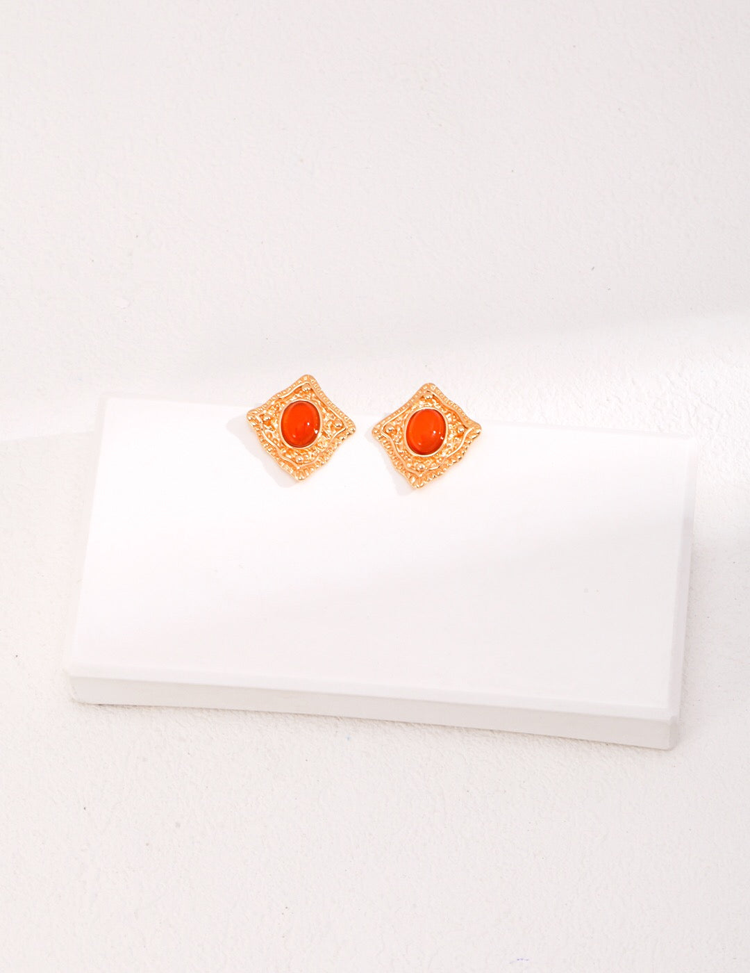 Handmade Lapis Lazuli and Carnelian stud earrings with gold vermeil setting, showcasing vibrant colors and elegant design.